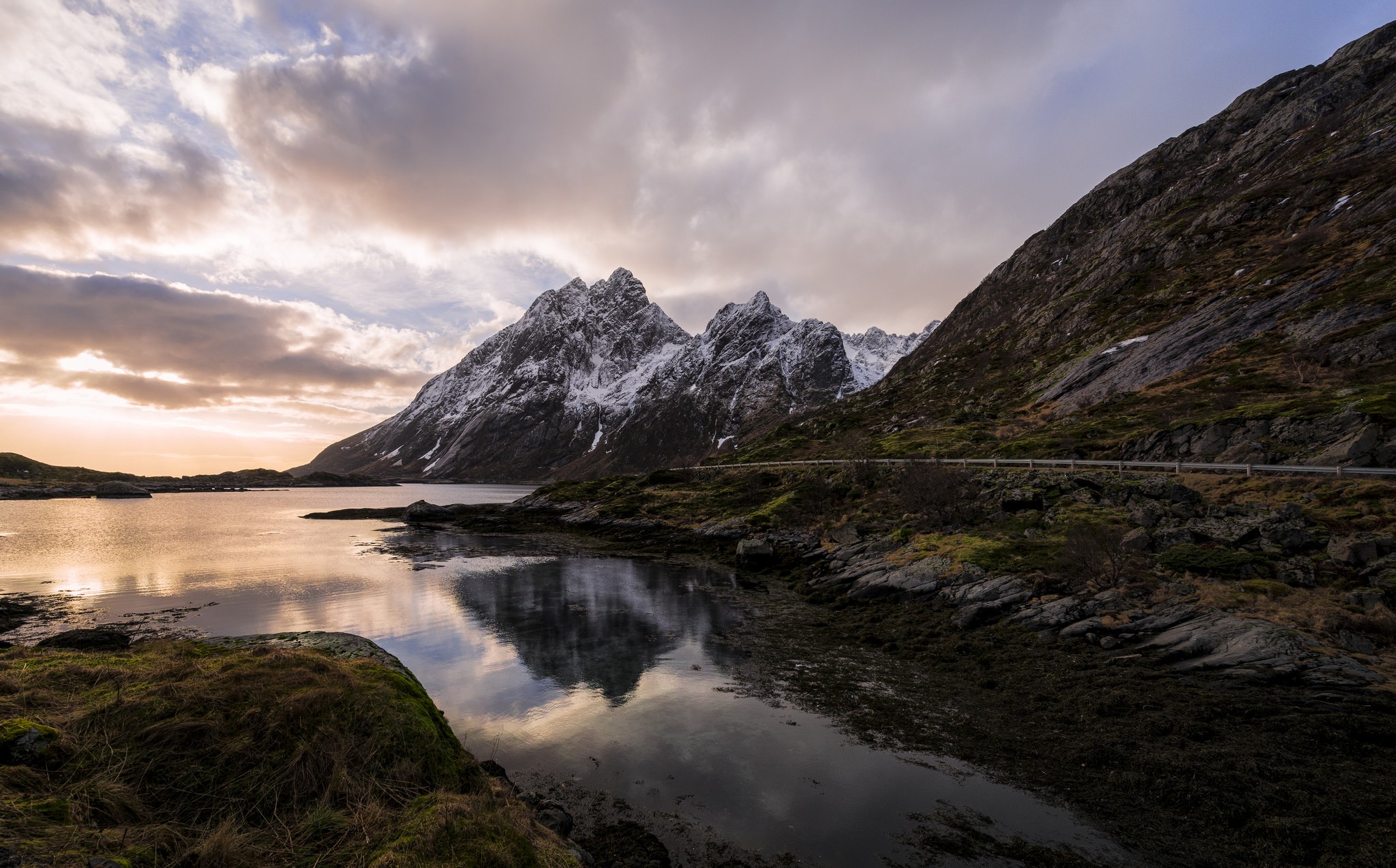 Snow-capped mountains reflected in a calm lake at sunset HD Wallpaper