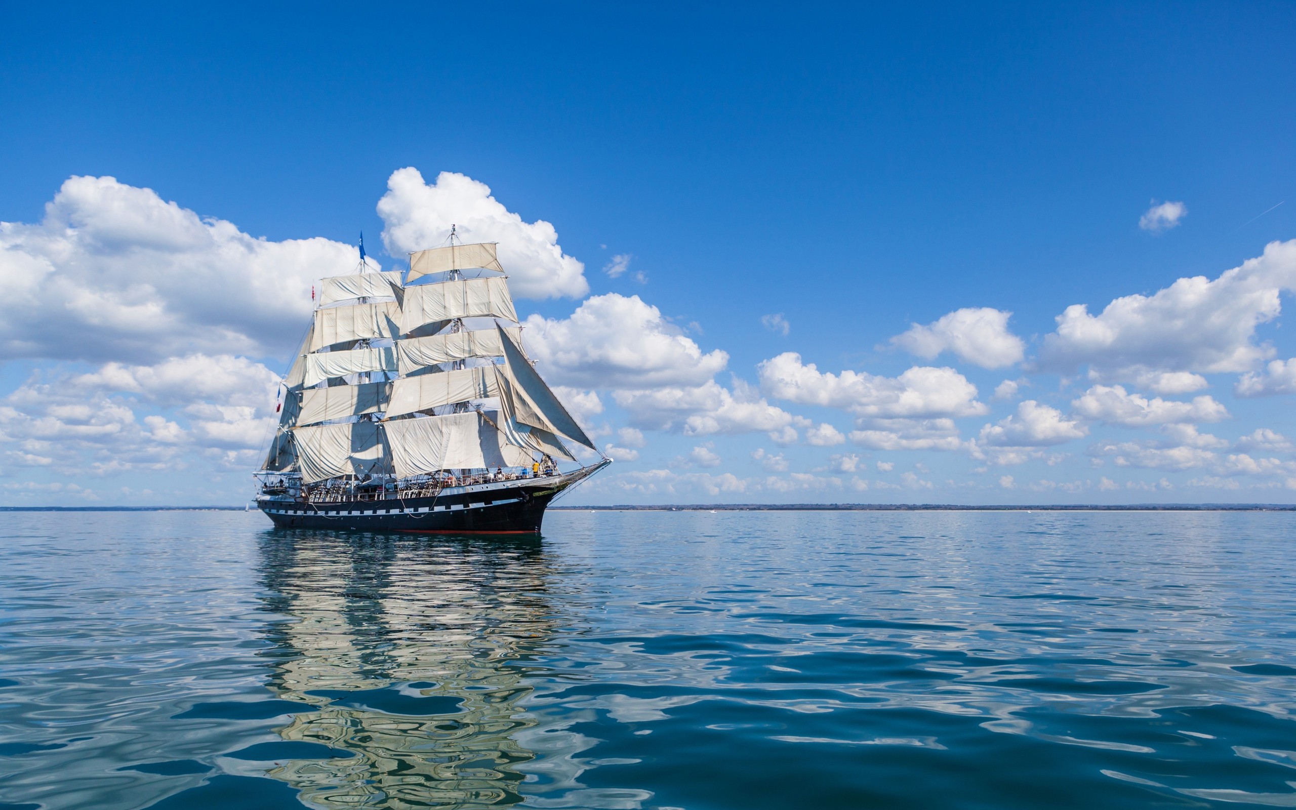 Tall ship sailing on a blue sea under clouds HD Wallpaper