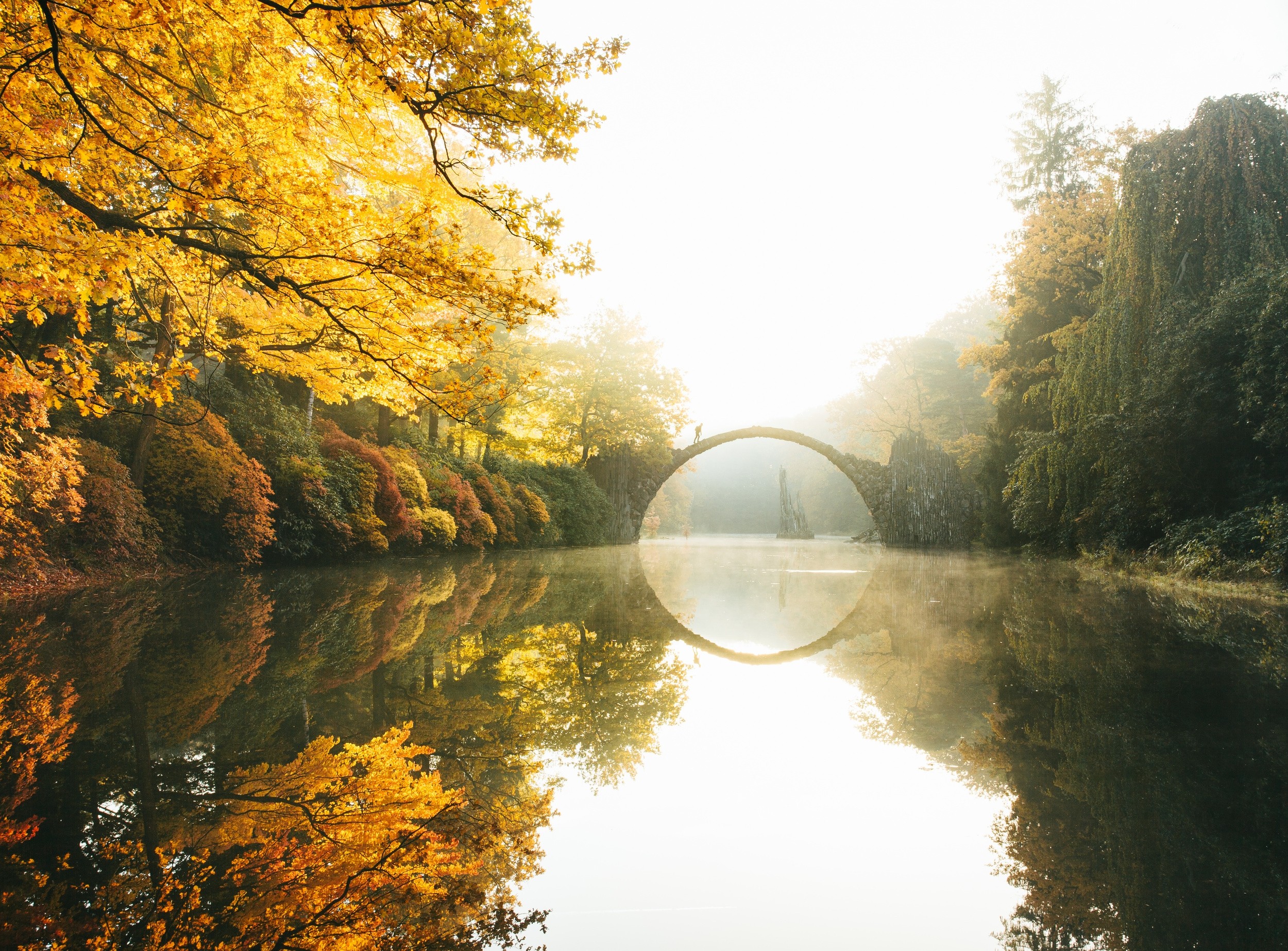 Rakotzbrücke bridge reflection in a lake during autumn HD Wallpaper