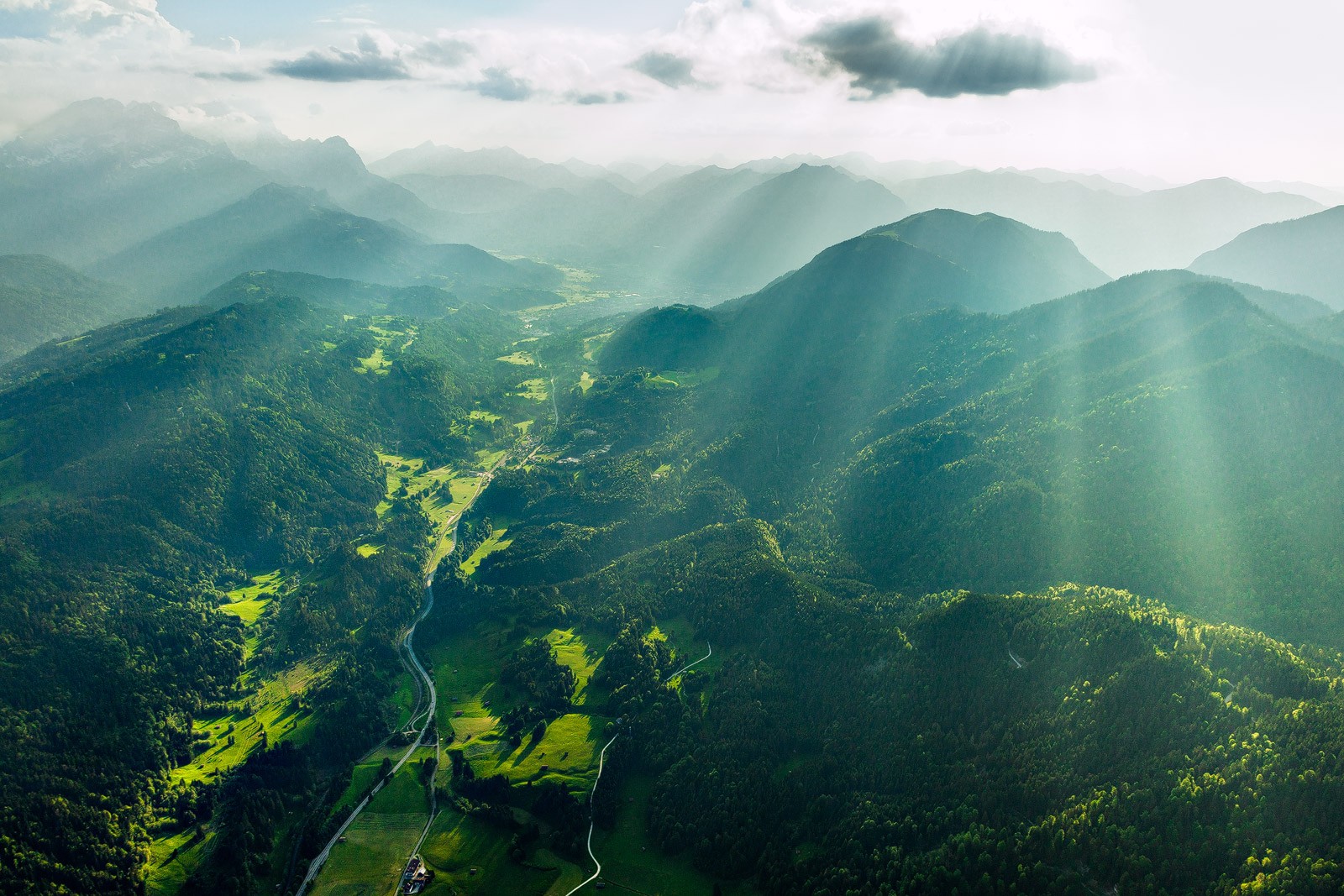 Sun rays over green mountains and valley HD Wallpaper