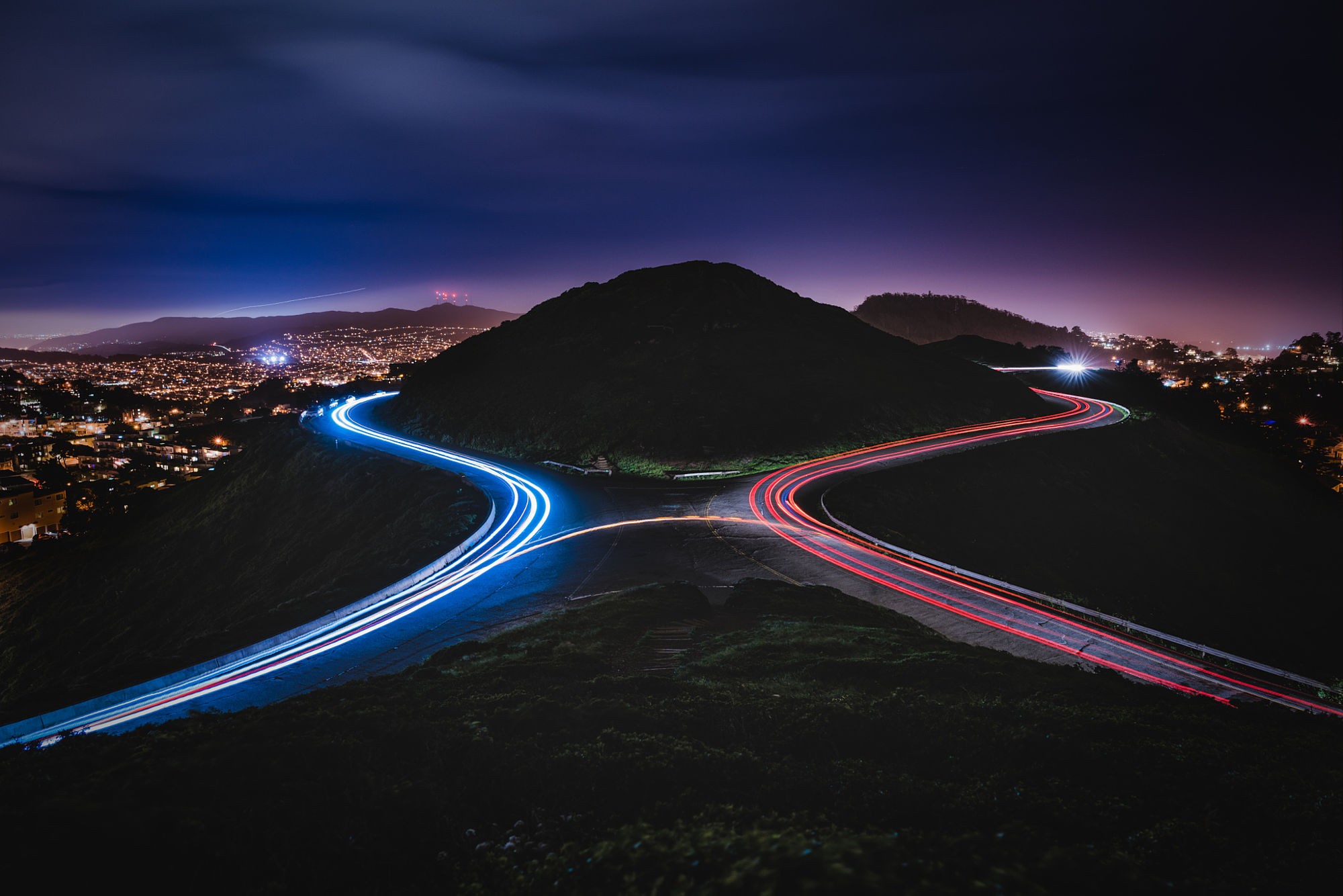 Long exposure light trails on a mountain road at night HD Wallpaper