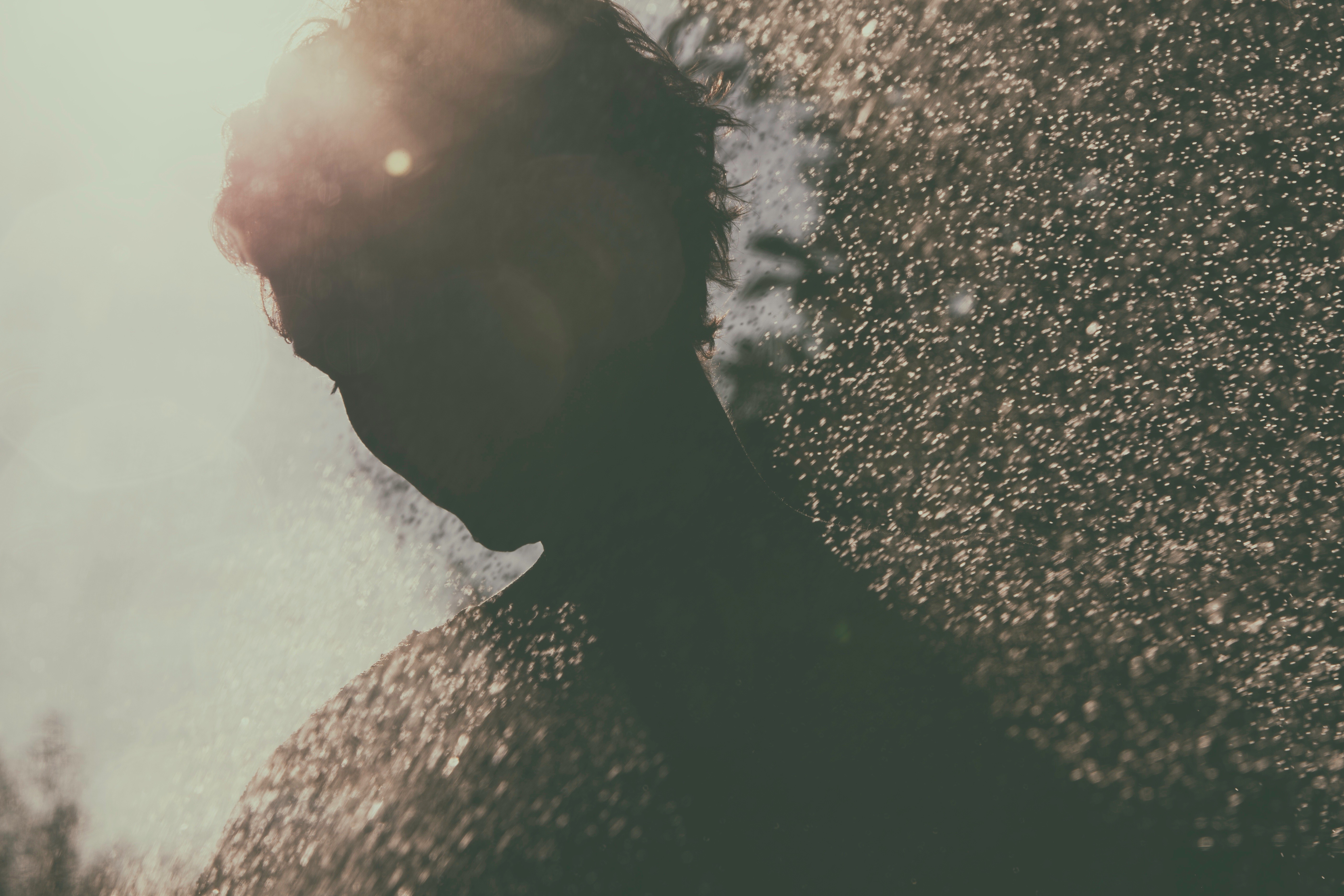 Silhouette of a person in water droplets HD Wallpaper