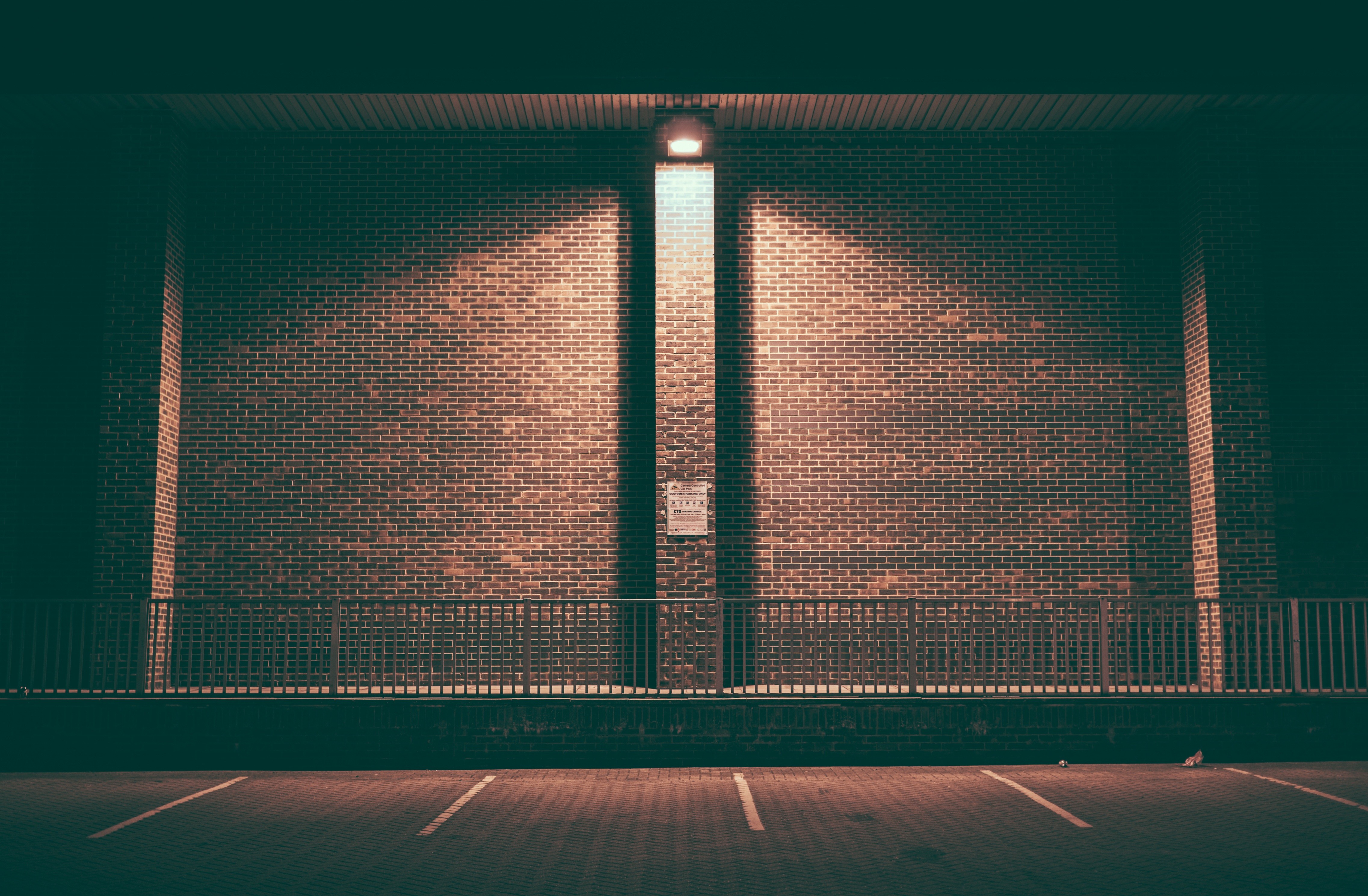 Brick wall with overhead light at night HD Wallpaper