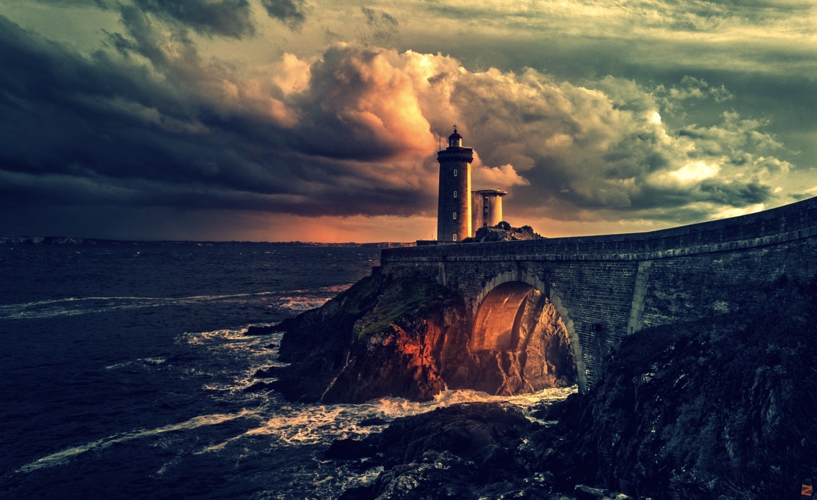 Lighthouse on a rocky coast under stormy clouds HD Wallpaper