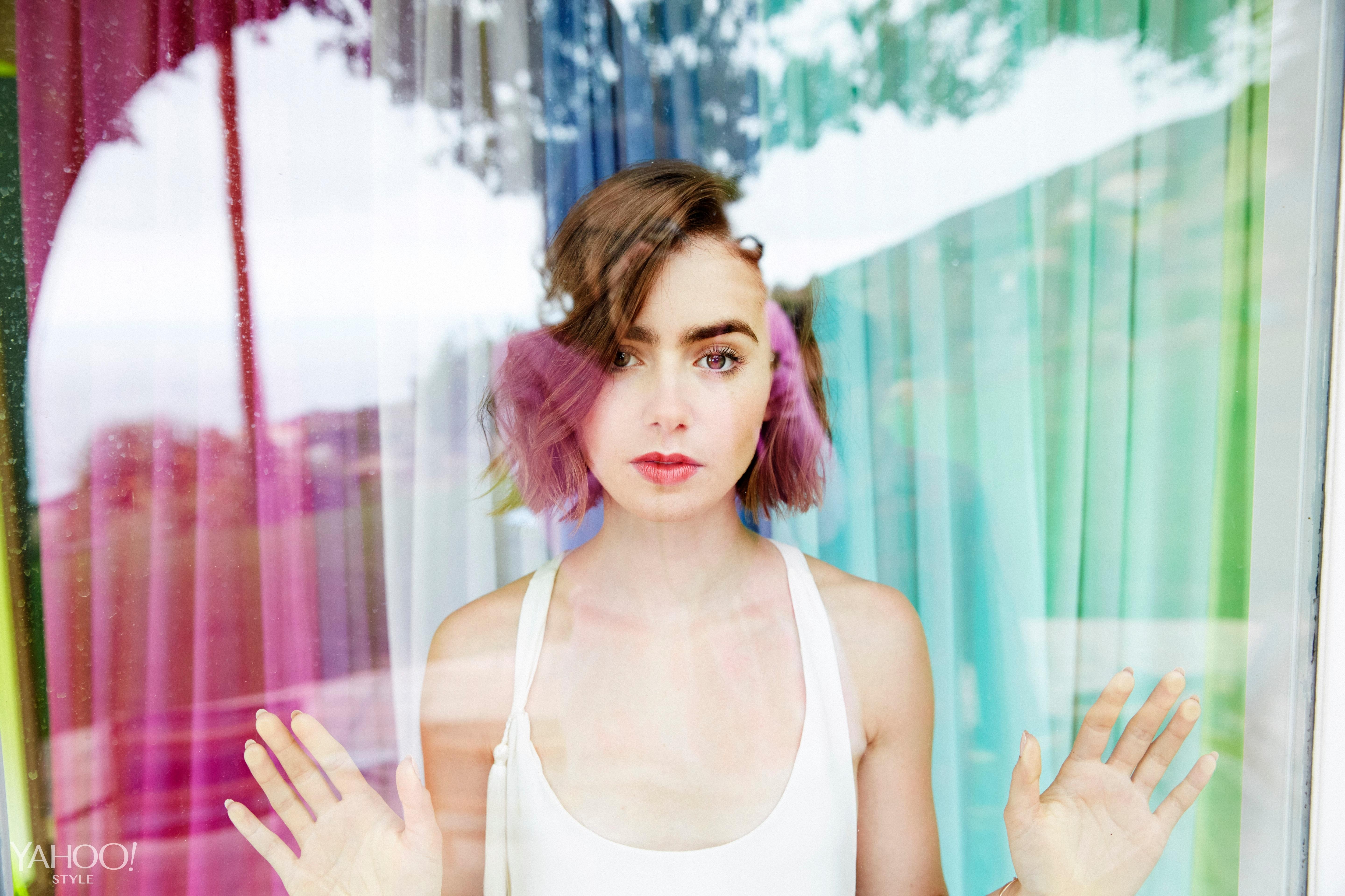 Lily Collins poses behind a colorful window HD Wallpaper