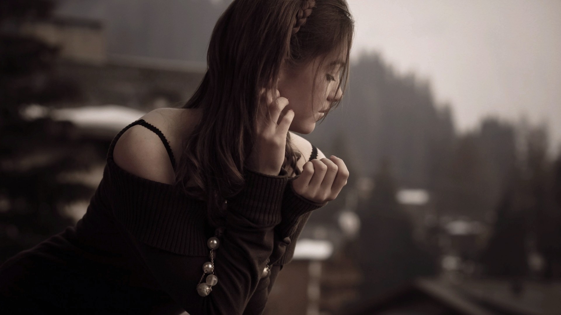 Woman with hands near face, looking down HD Wallpaper