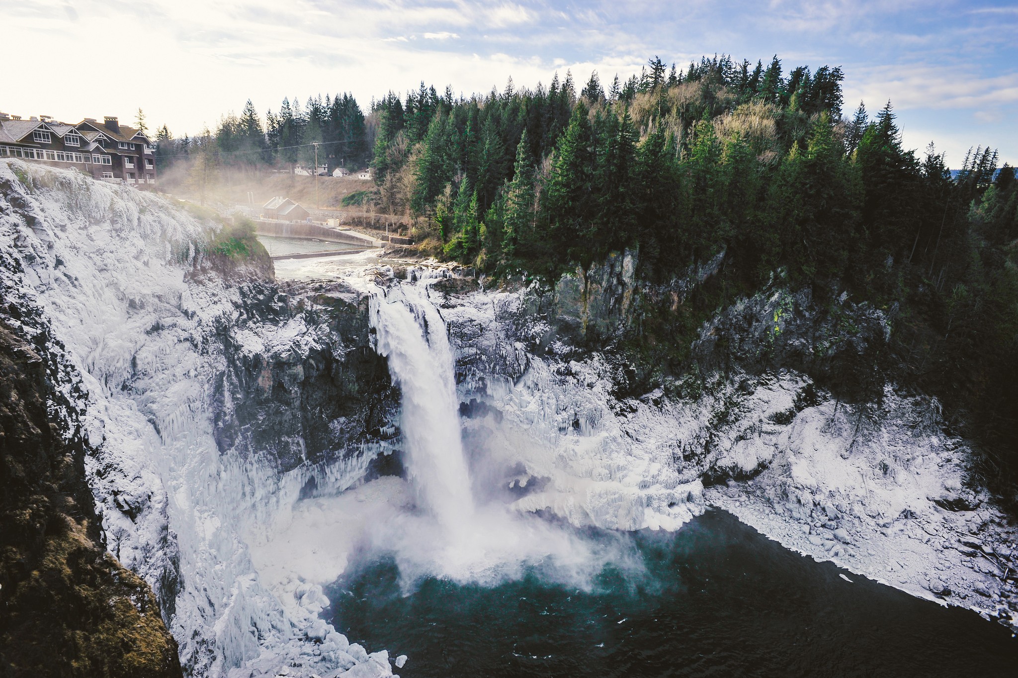 Waterfall surrounded by ice and evergreen forest HD Wallpaper