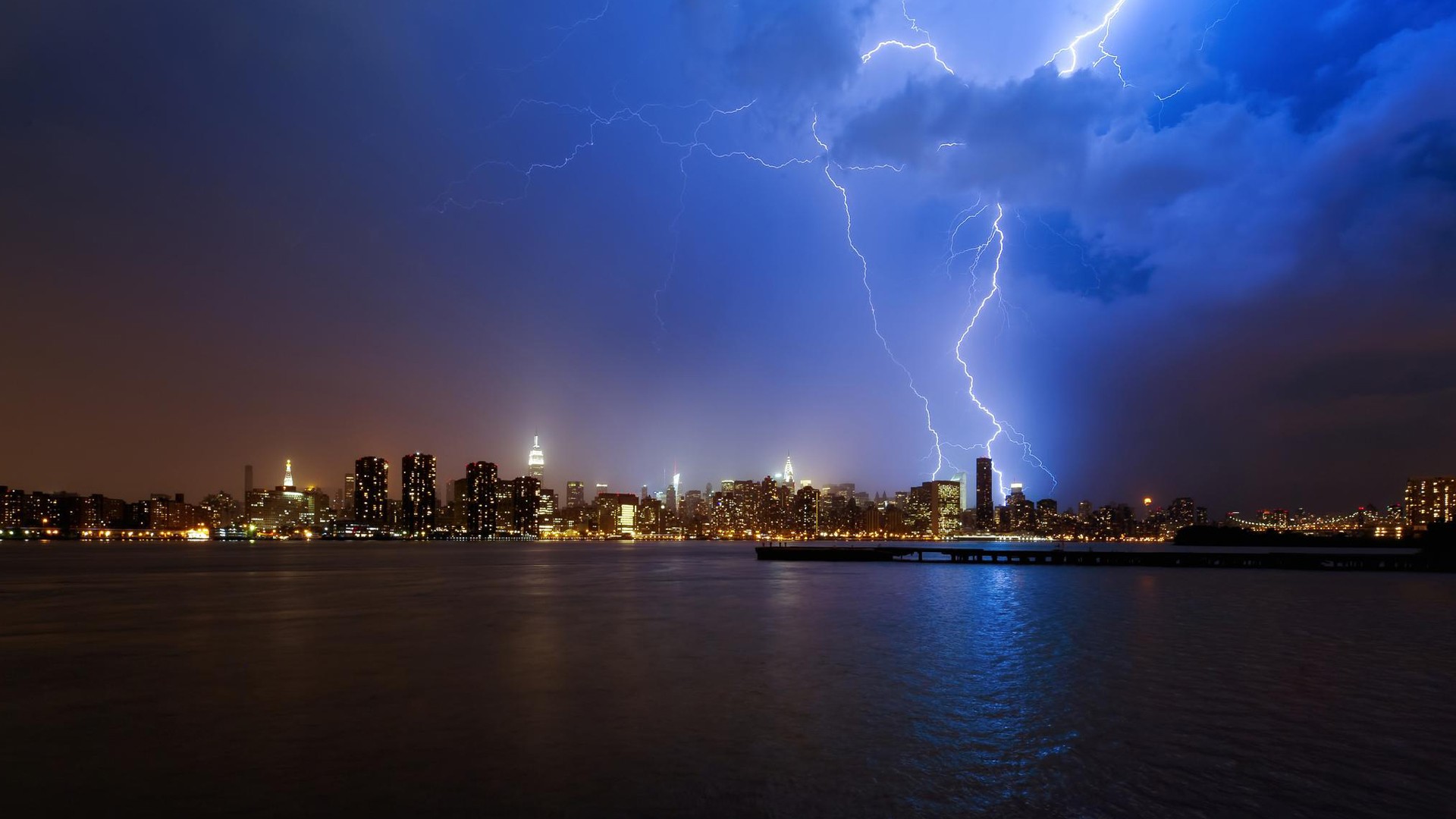 New York City skyline during a lightning storm HD Wallpaper