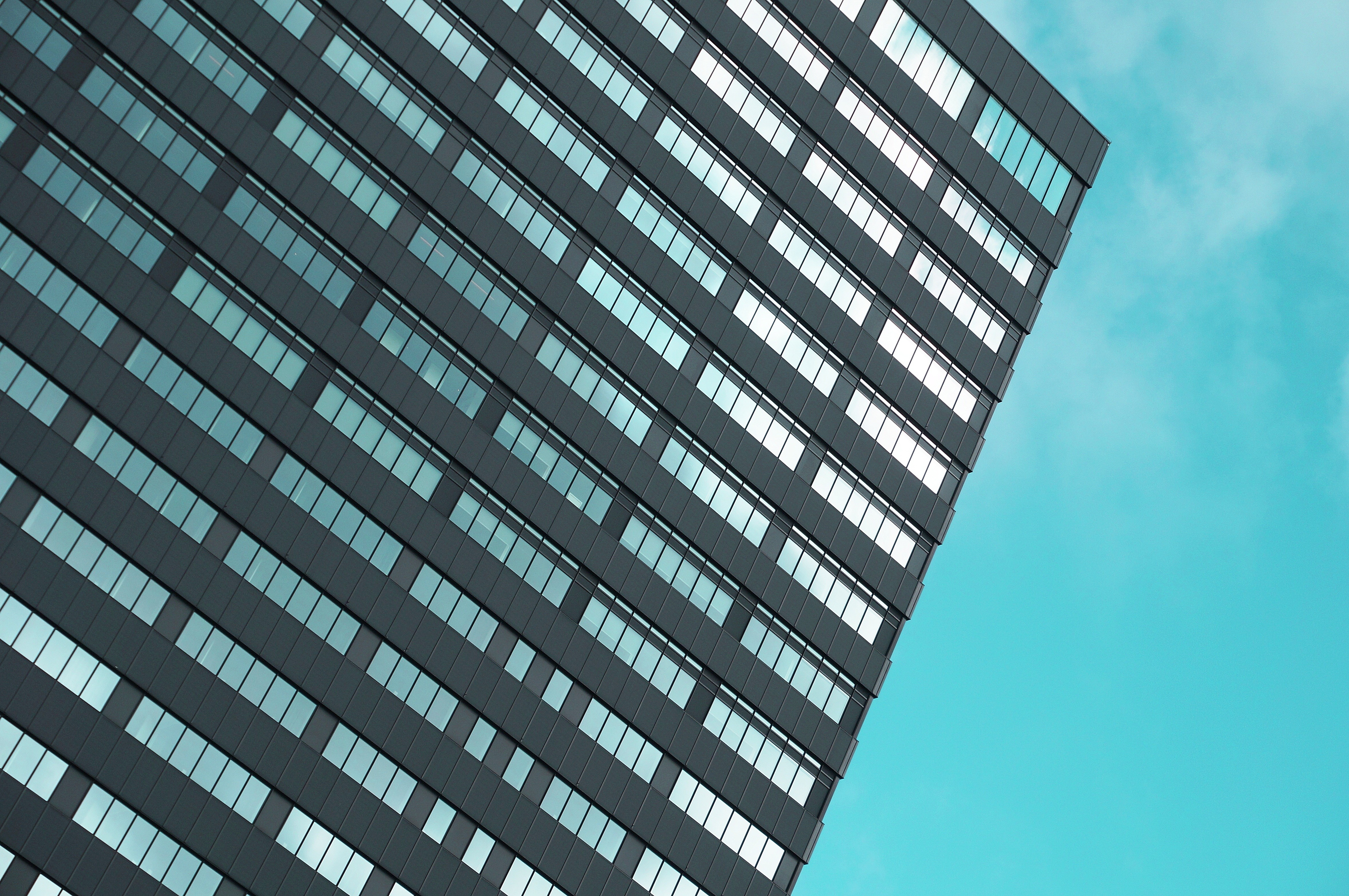 Modern building facade with geometric window pattern HD Wallpaper