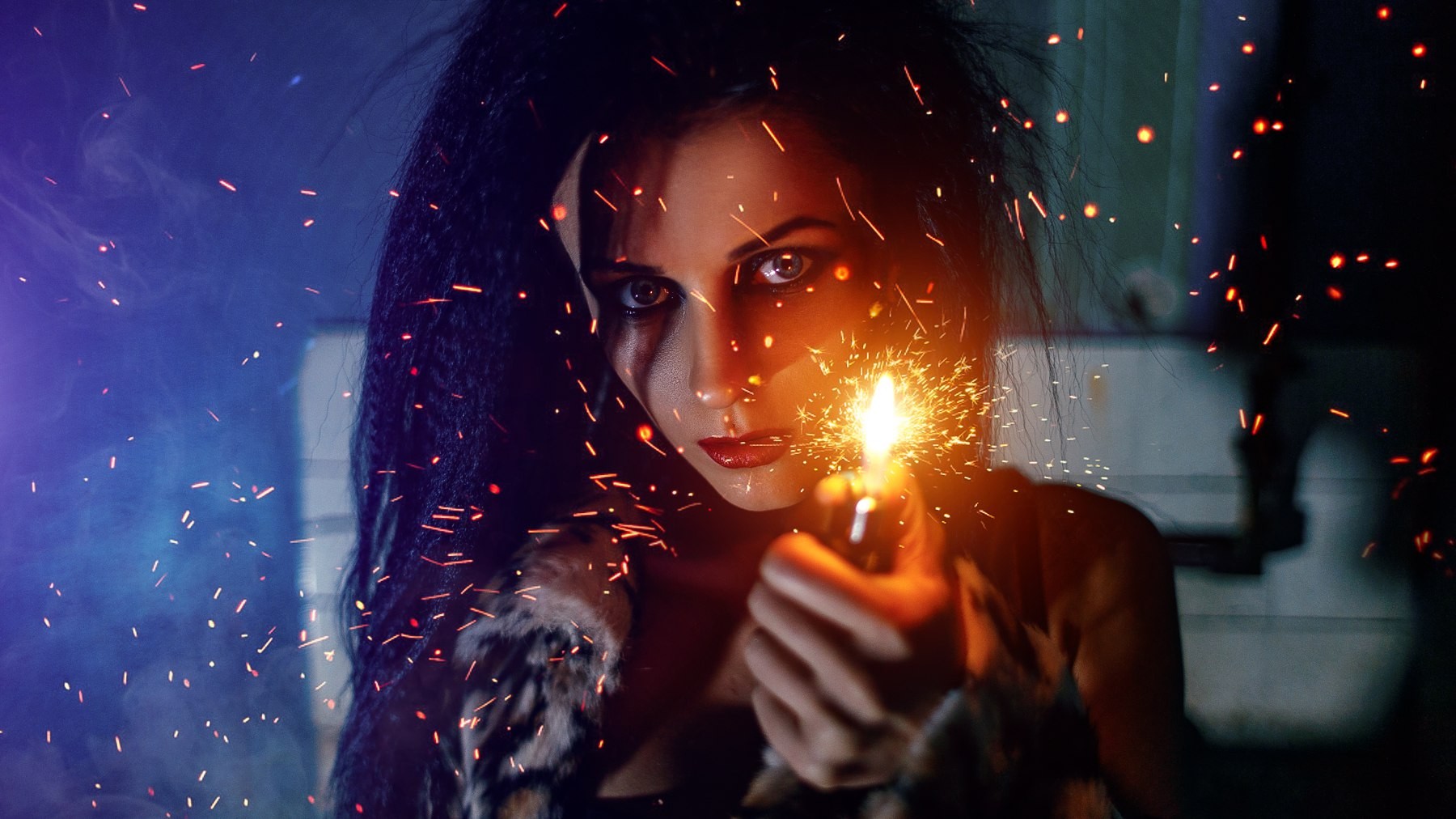 Woman holding a lit lighter with sparks flying HD Wallpaper