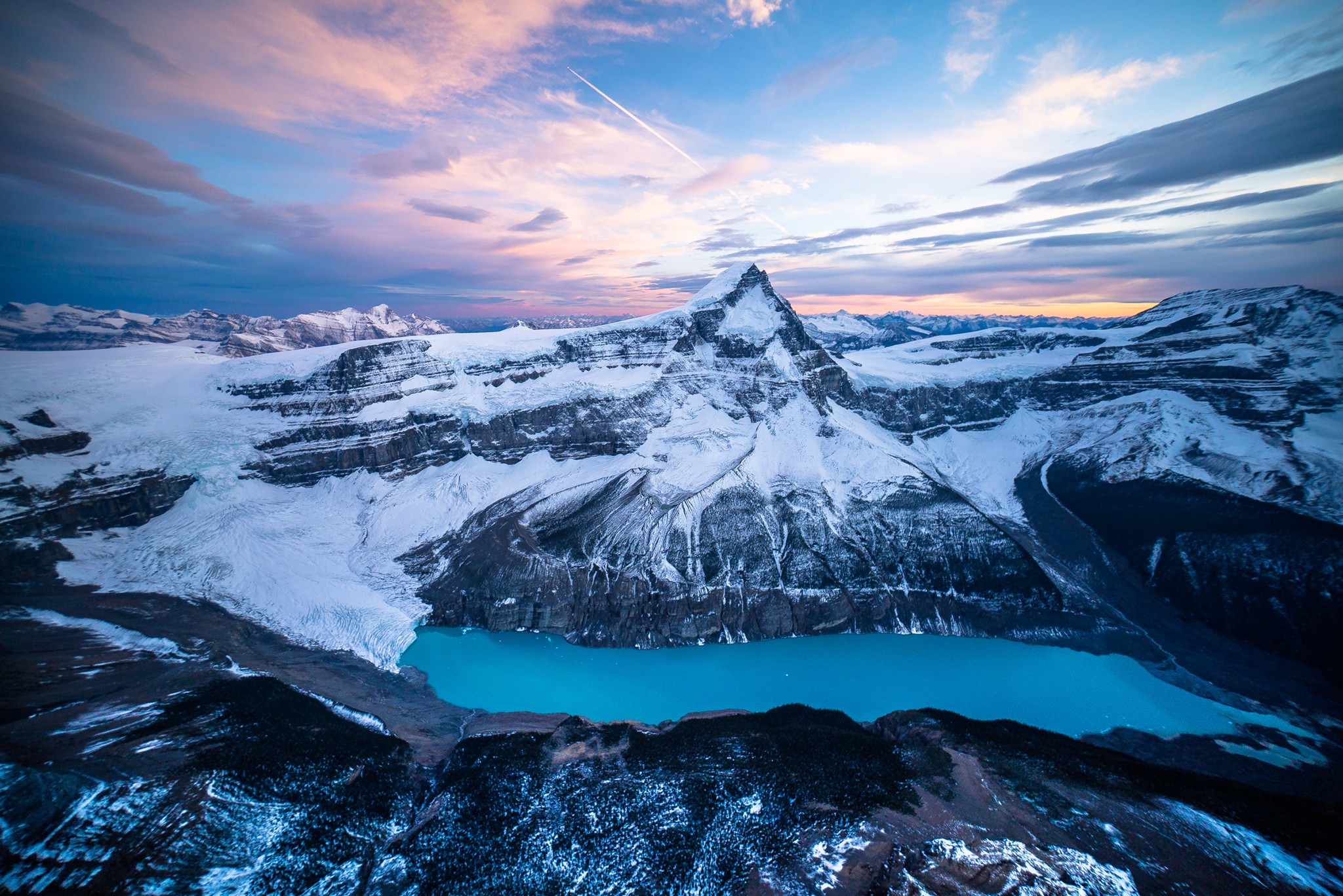 Snow-covered mountains and a turquoise lake at sunset HD Wallpaper