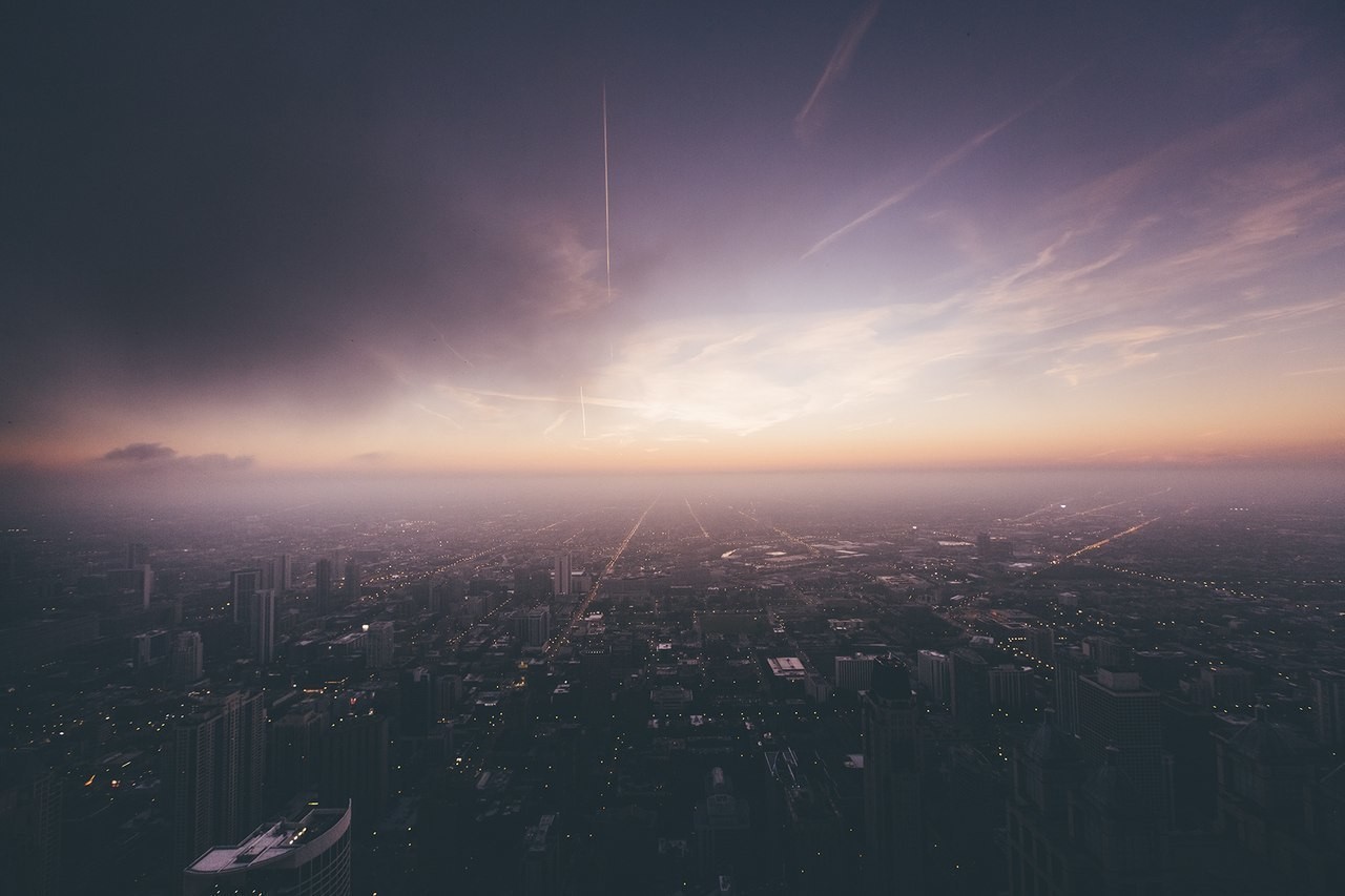 Cityscape at Dusk with Airplane Trails HD Wallpaper