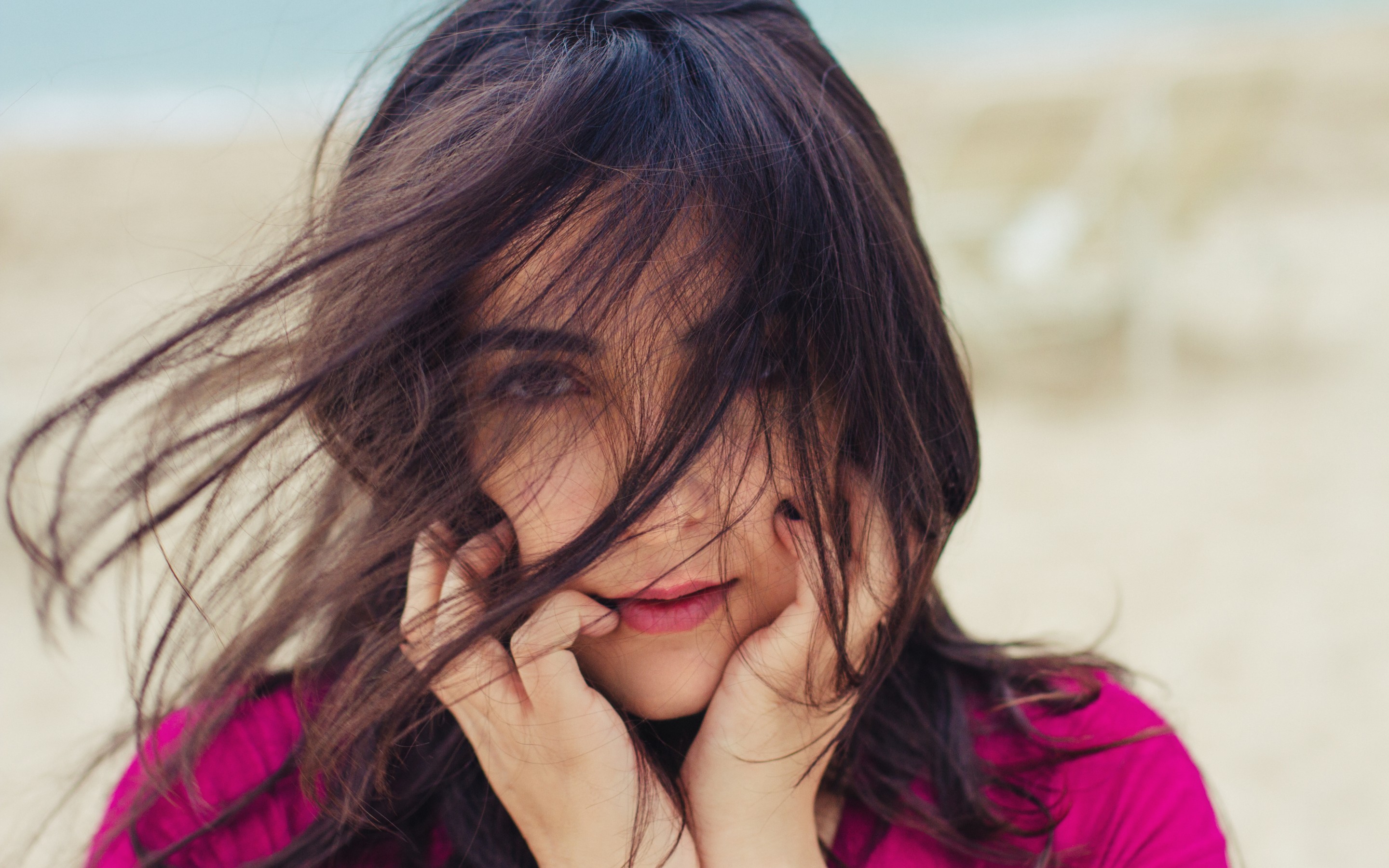 Woman with long dark hair in the wind HD Wallpaper