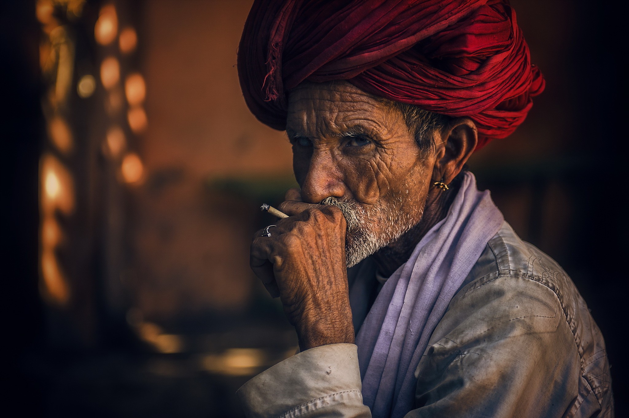 Elderly man with red turban smoking a cigarette HD Wallpaper