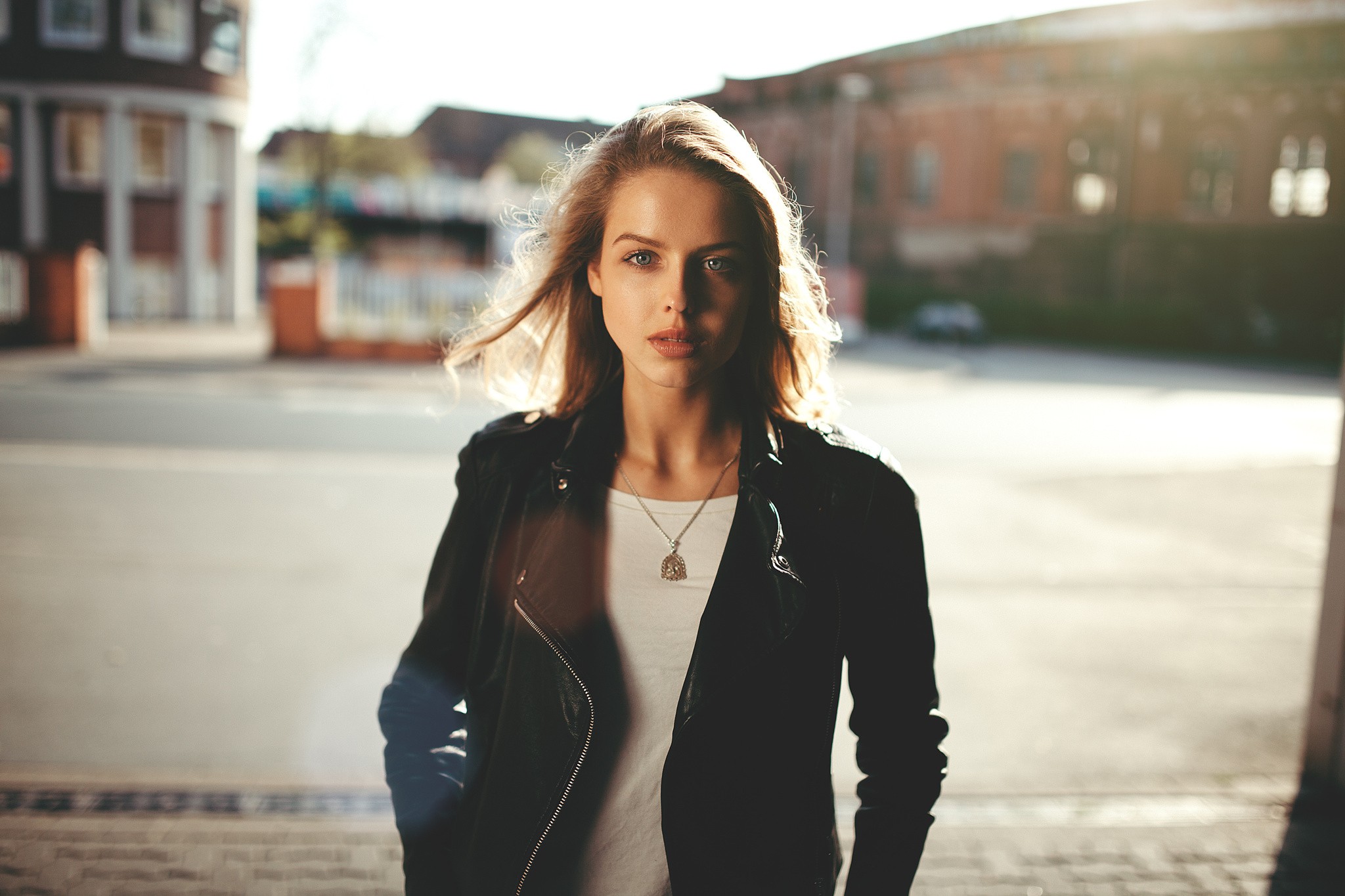 Woman in leather jacket standing outside HD Wallpaper
