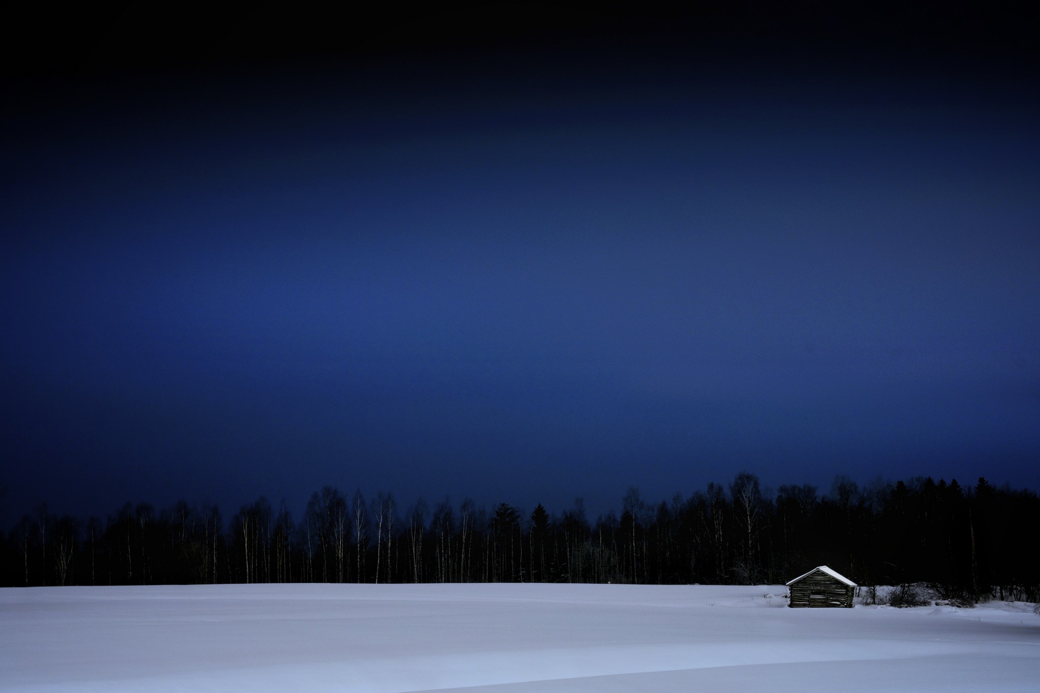 Small wooden shed in a snowy field in Estonia HD Wallpaper