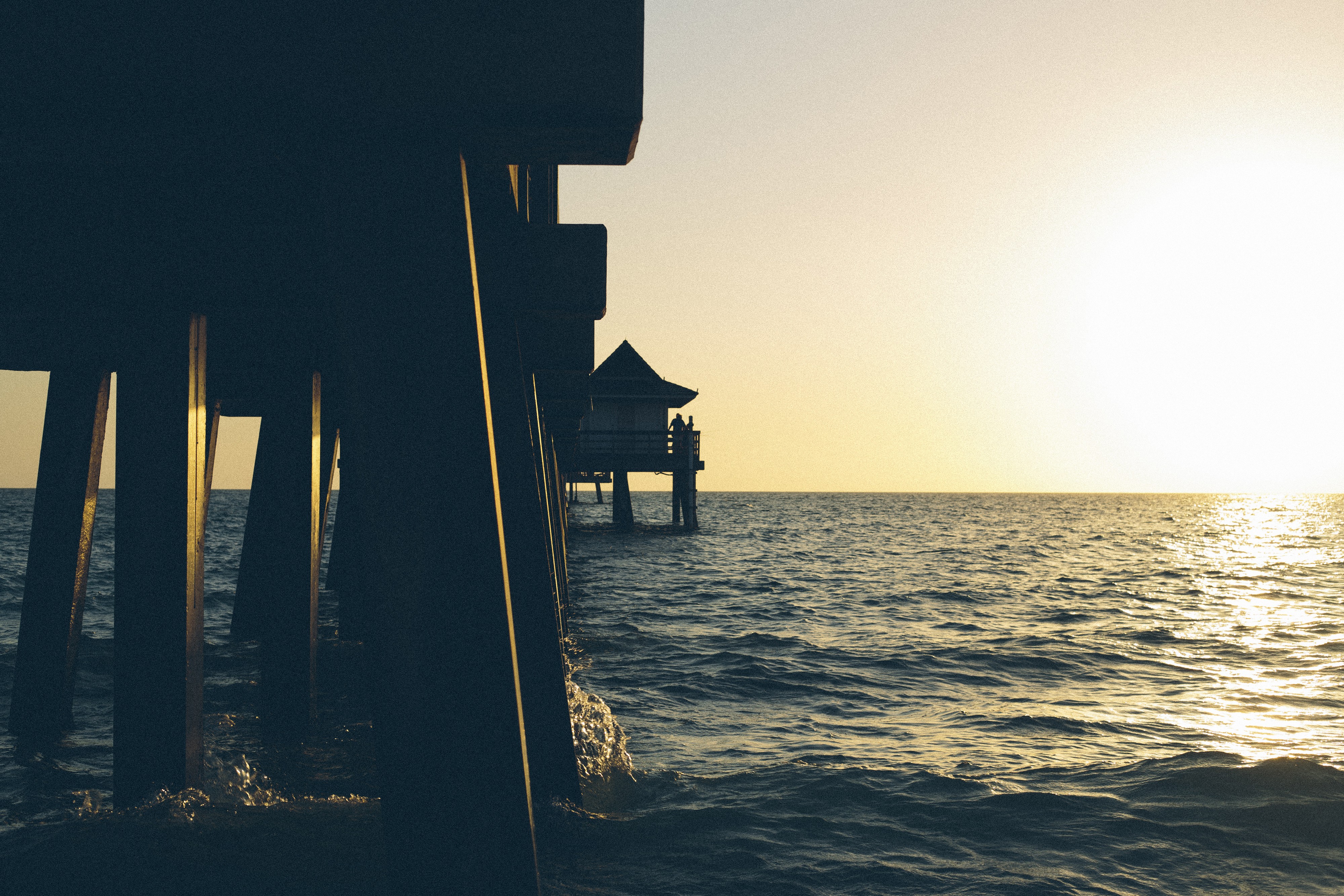 Pier over the sea at sunset HD Wallpaper