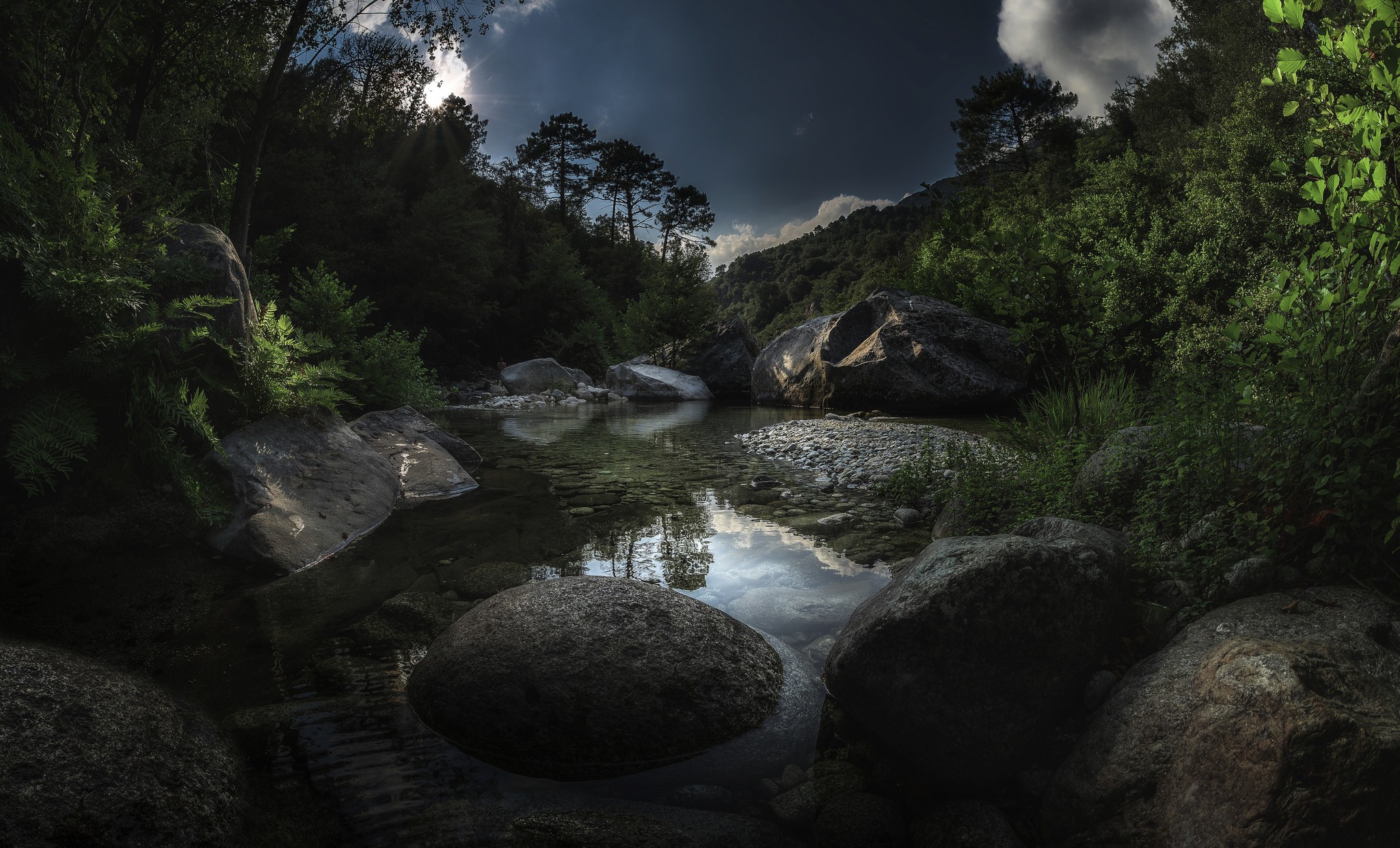 River flowing through a rocky forest landscape HD Wallpaper