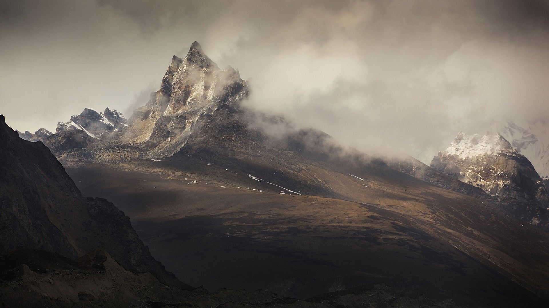 Misty mountains with snow-capped peaks HD Wallpaper