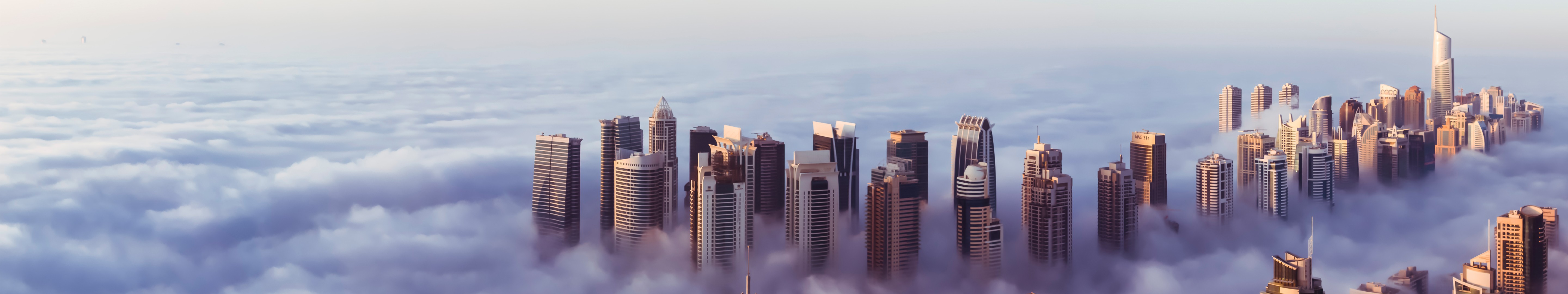 Dubai skyscrapers emerge from clouds in a panoramic view HD Wallpaper