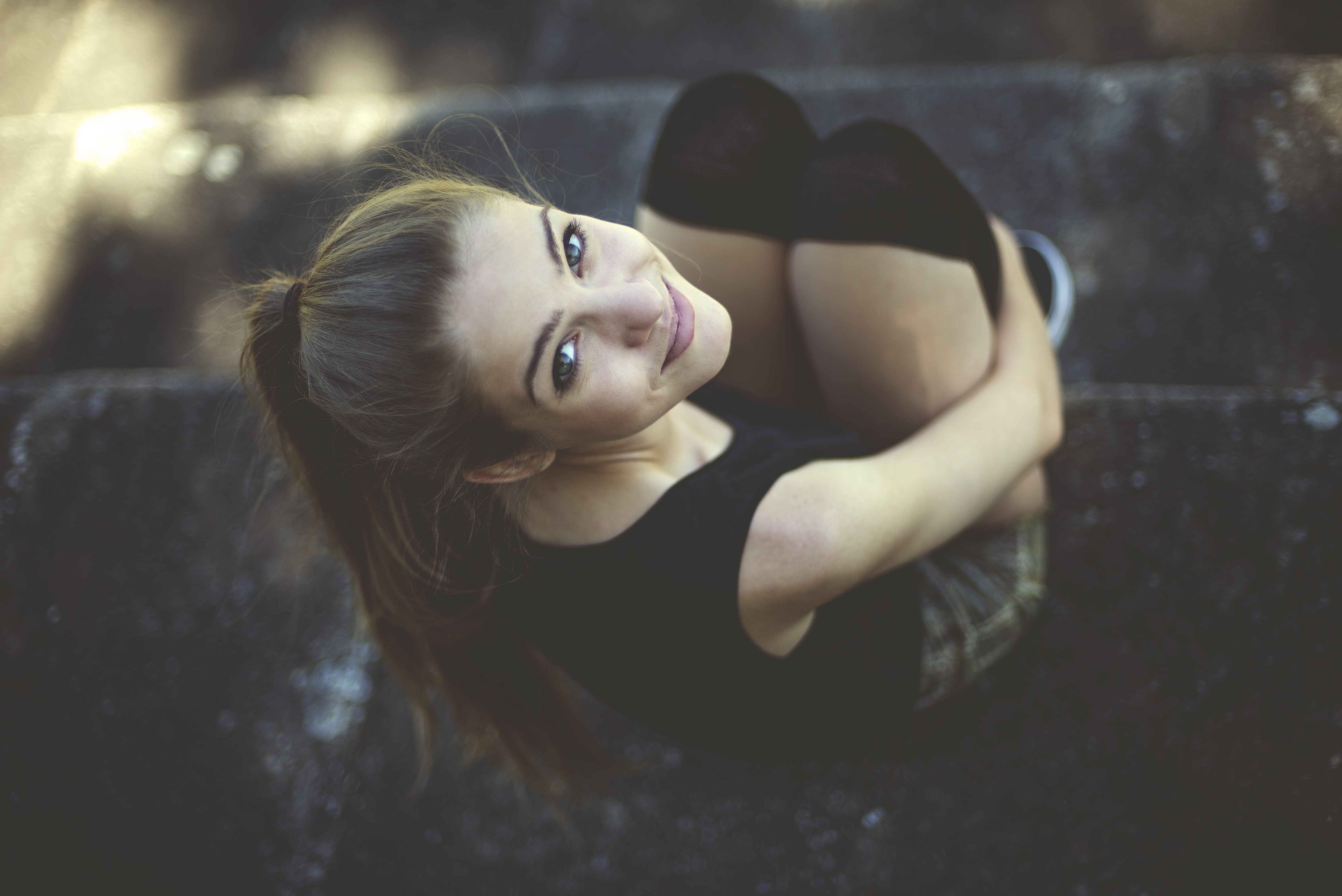 Woman with ponytail sitting on stairs HD Wallpaper
