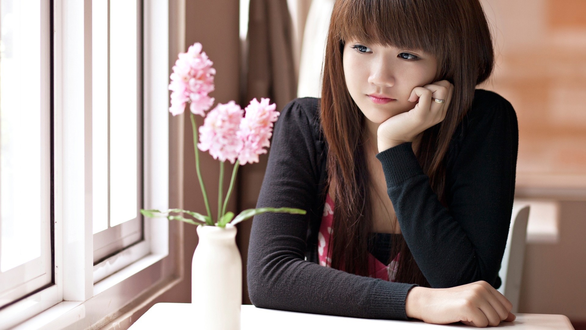 Young Asian woman looking out a window HD Wallpaper