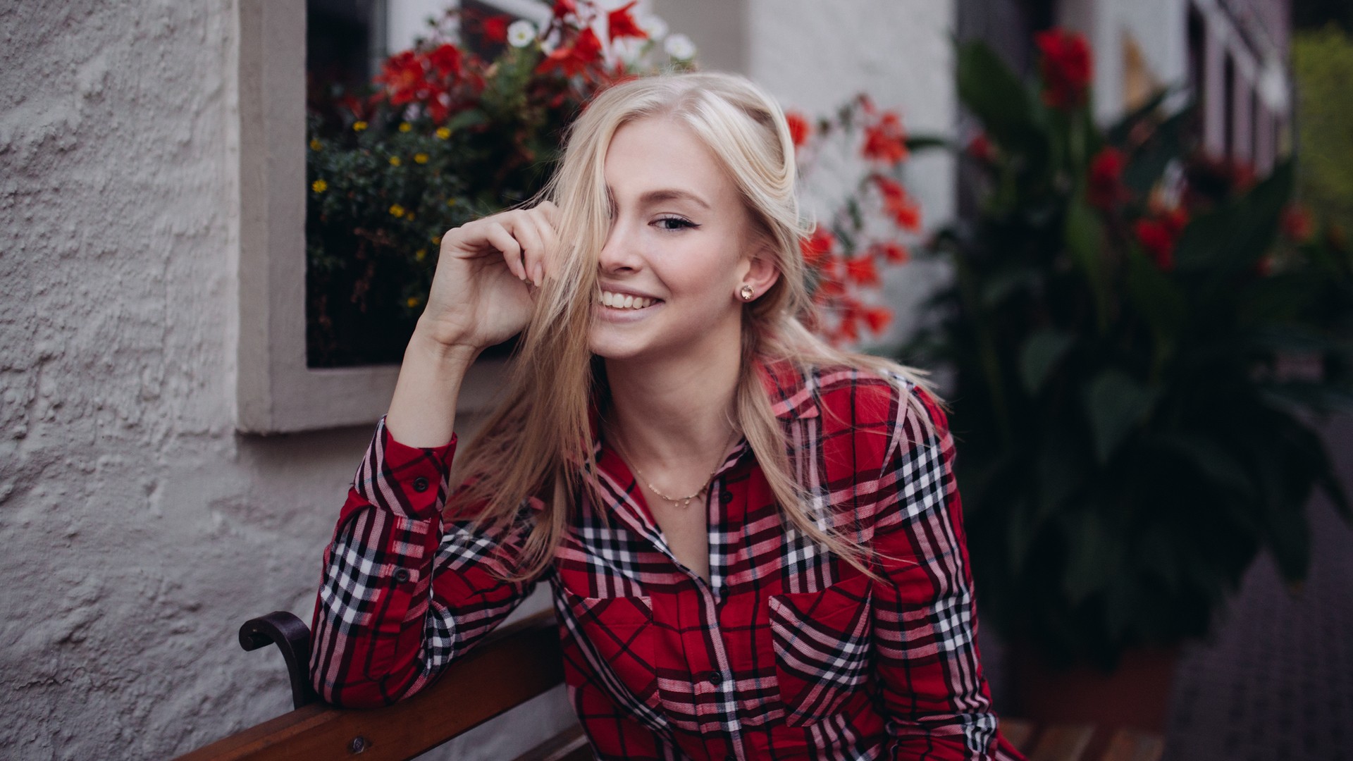 smiling, women outdoors, blonde, flowers, sitting, looking at viewer, shirt, model, checkered, plaid shirt, house, bench, hair in face, women, long hair HD Wallpaper