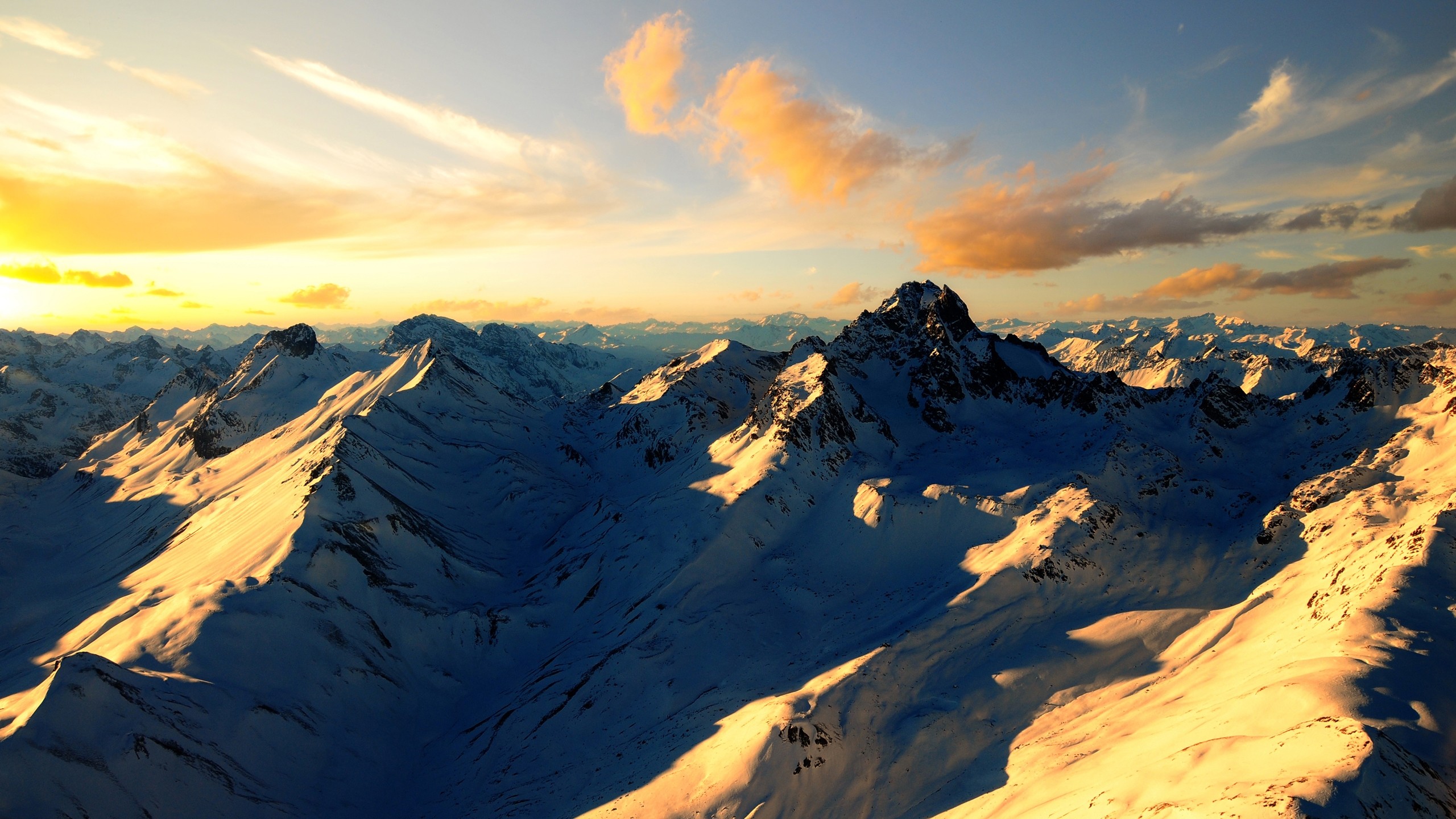 Snow-covered mountains at sunset HD Wallpaper