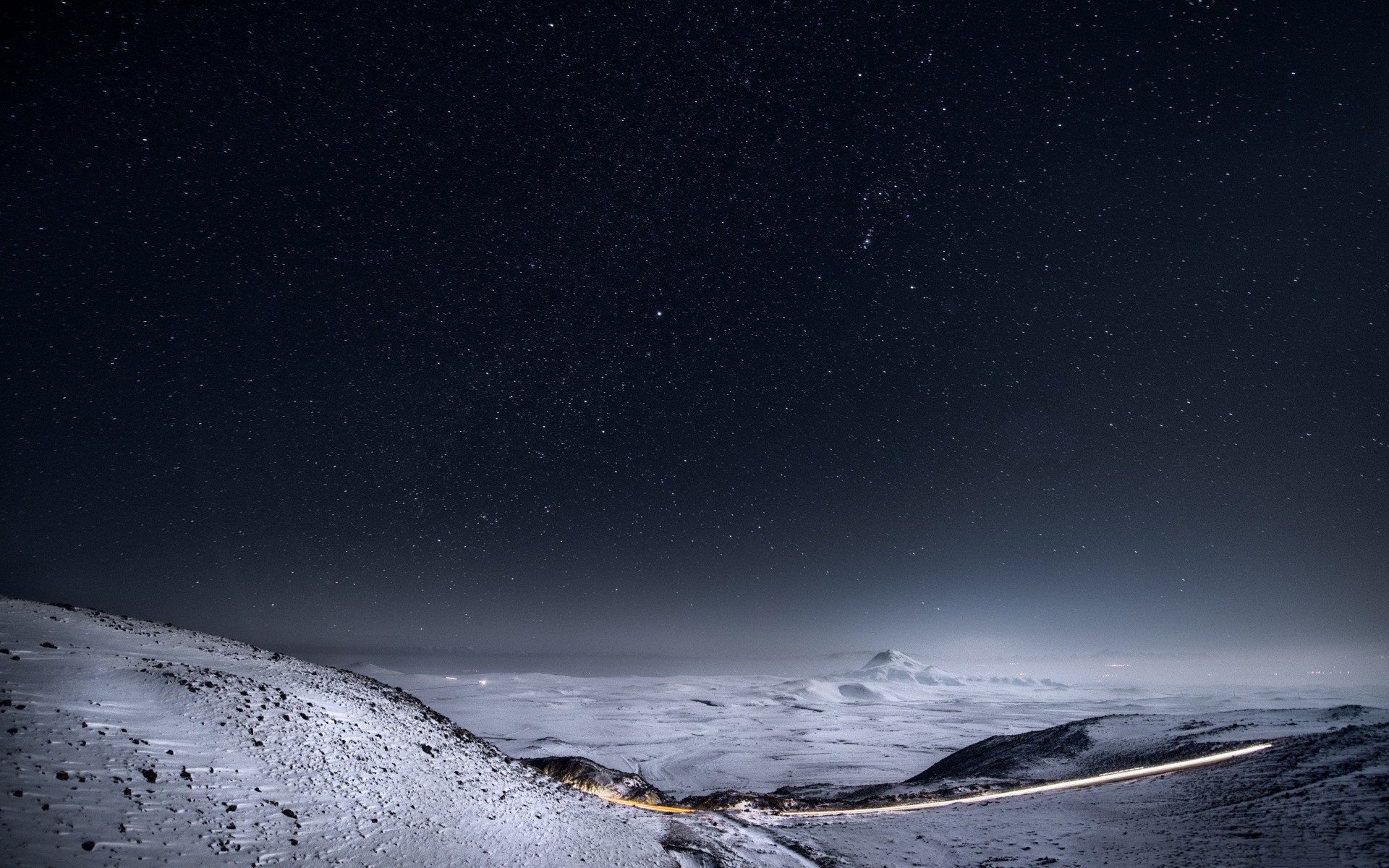Snowy landscape under a starry night sky HD Wallpaper