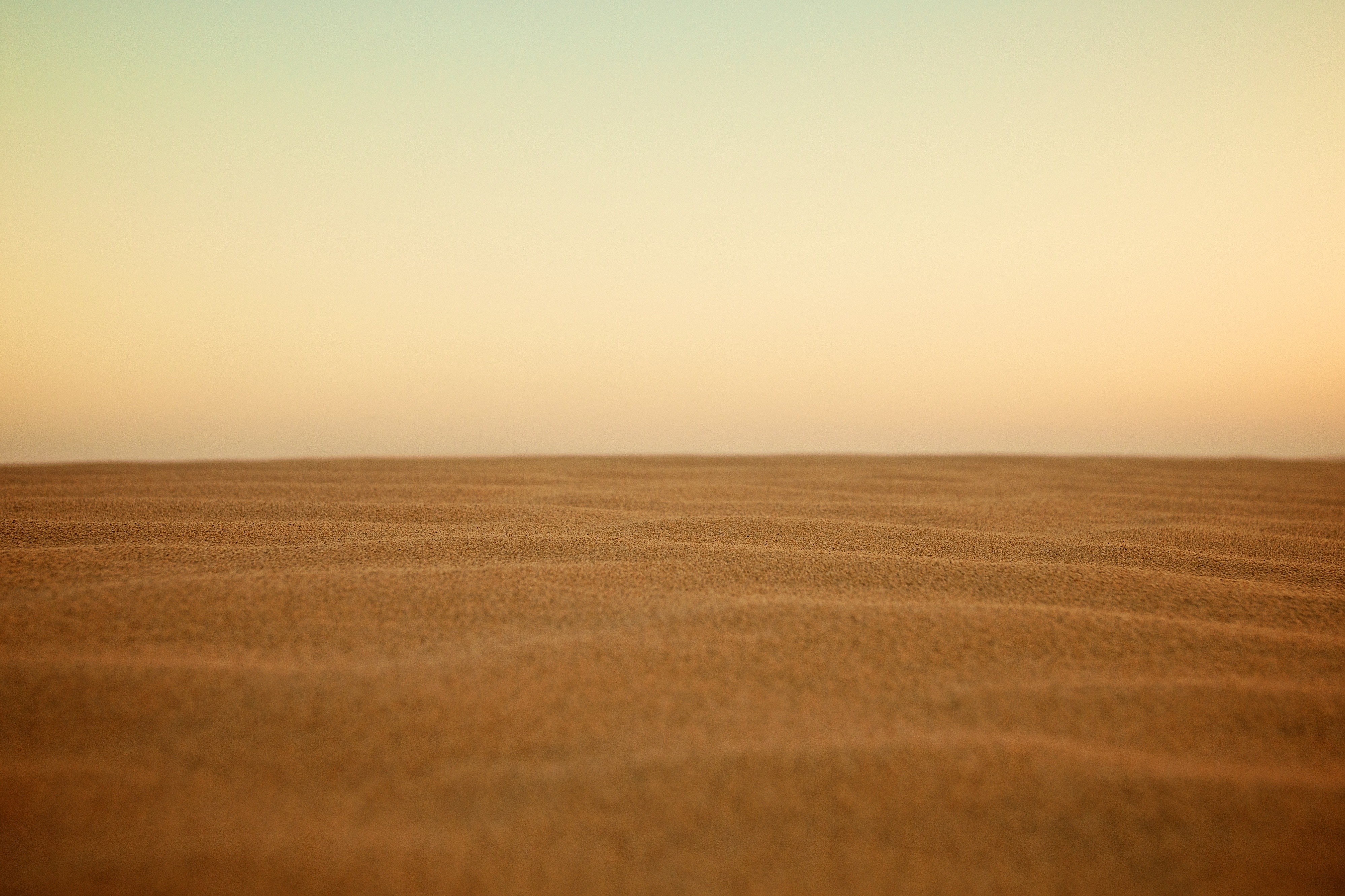 Minimalist sand dunes under a gradient sky HD Wallpaper