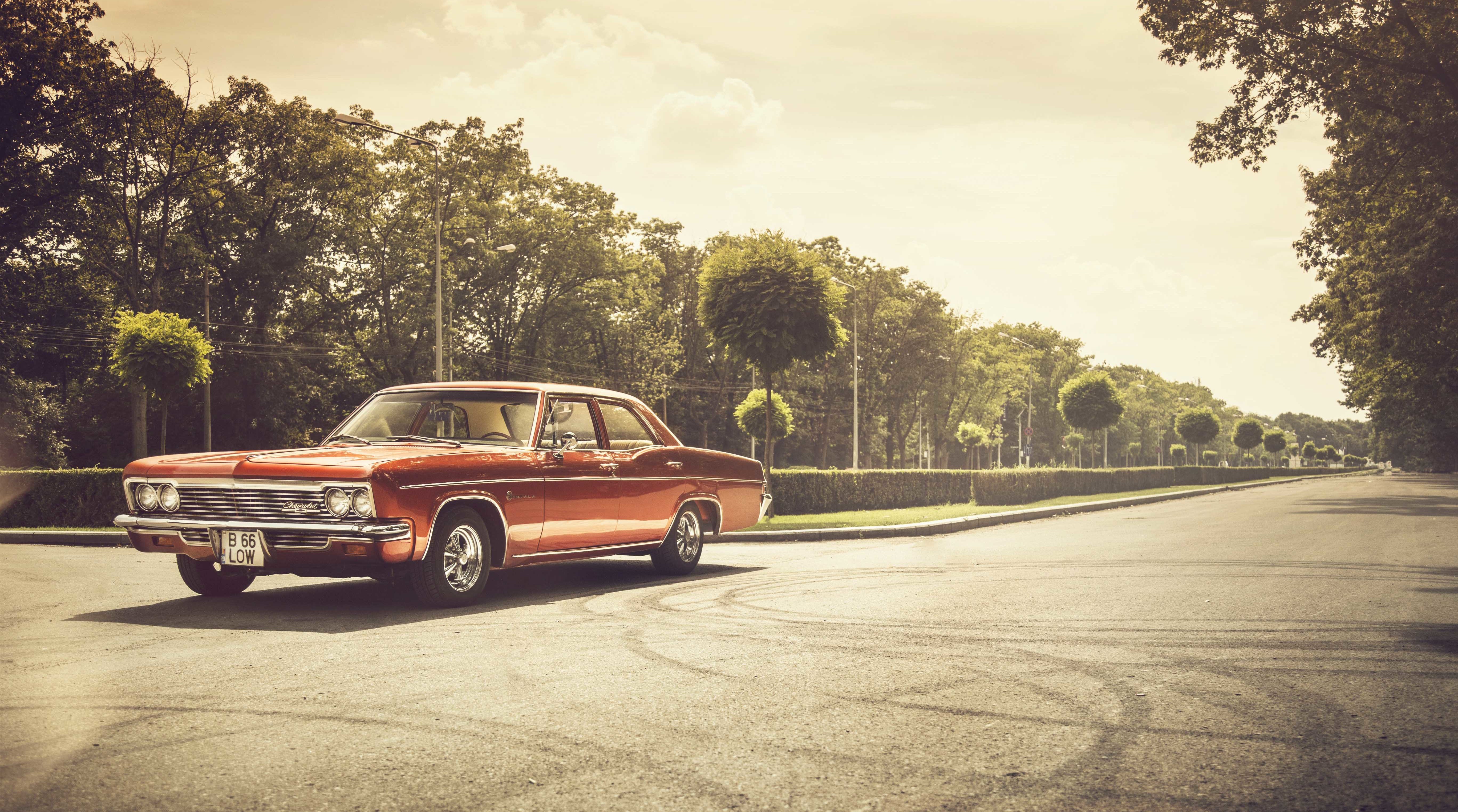 Red vintage Chevrolet Impala parked on asphalt road HD Wallpaper