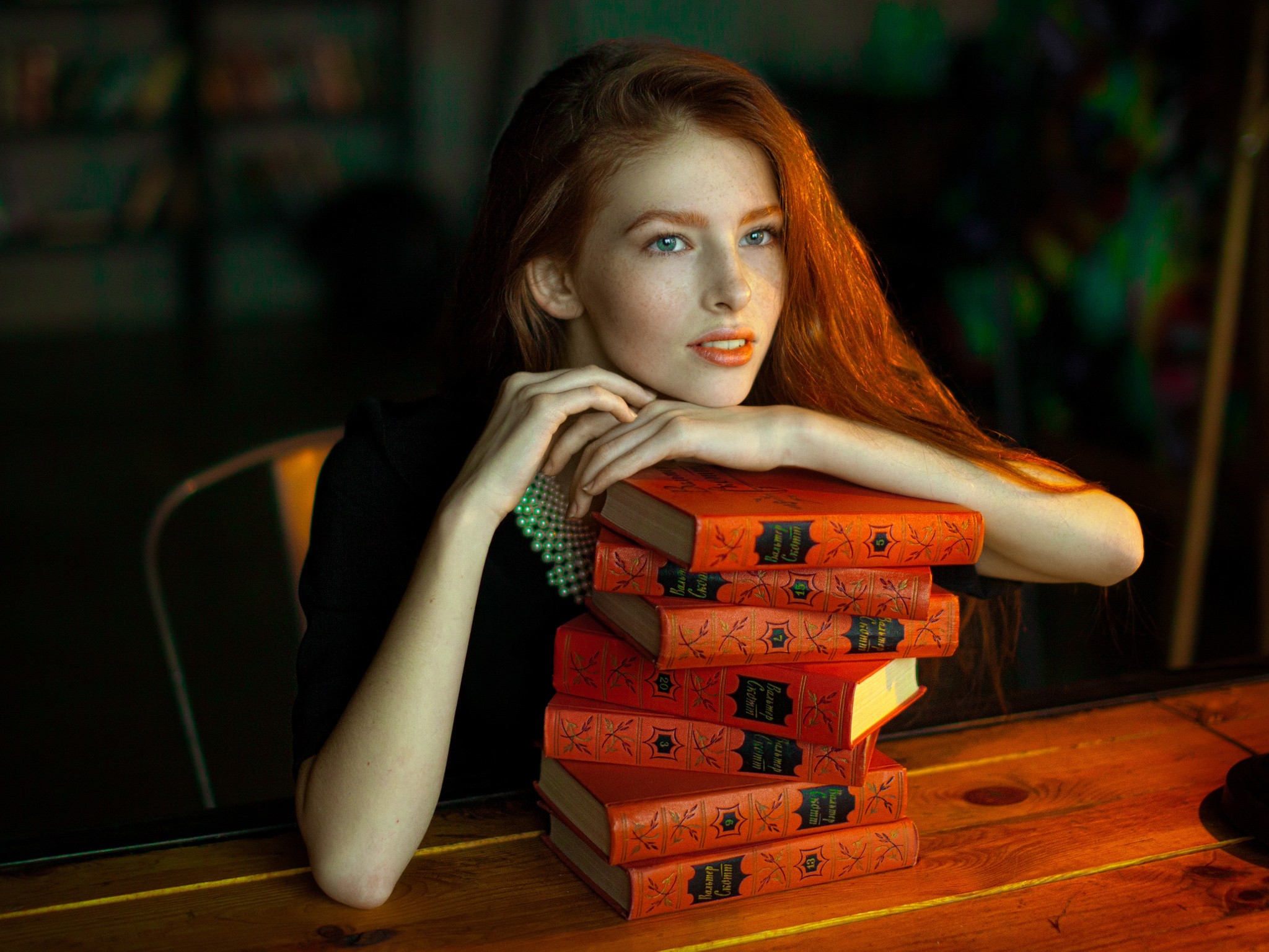 Redhead woman resting her head on a stack of books HD Wallpaper