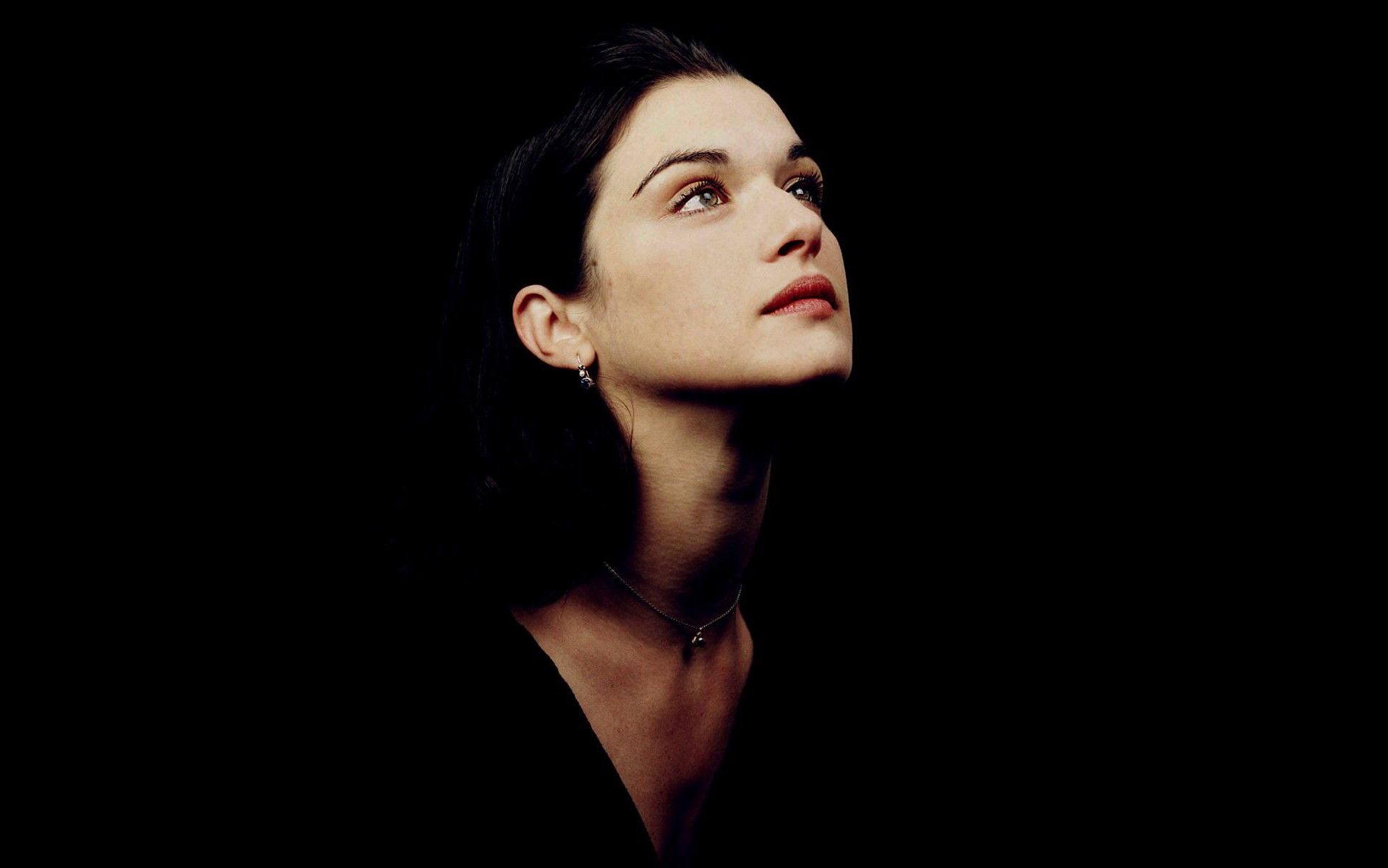 Rachel Weisz looking up against a black background HD Wallpaper