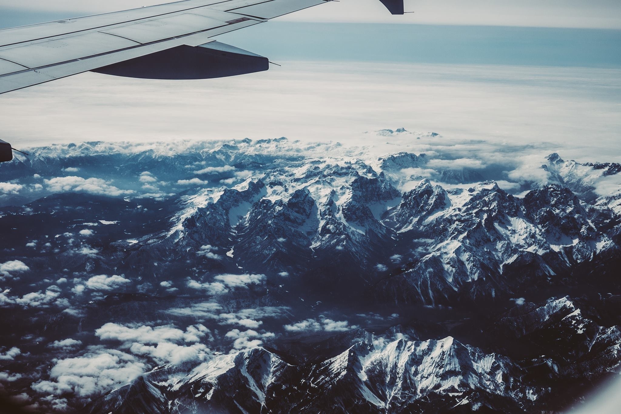 Aerial view of snow-covered mountains from an airplane HD Wallpaper