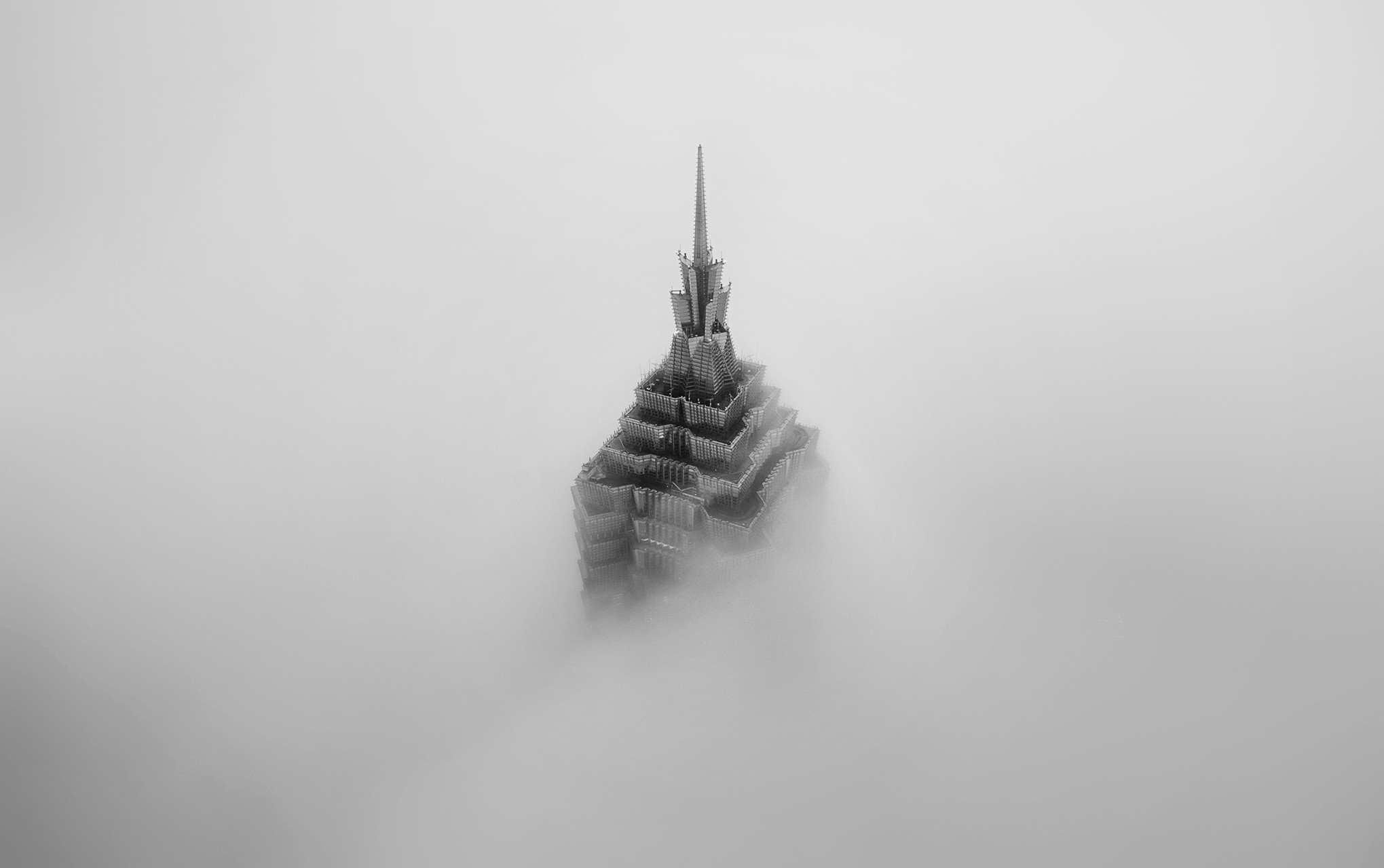 Monochrome skyscraper emerging from fog HD Wallpaper