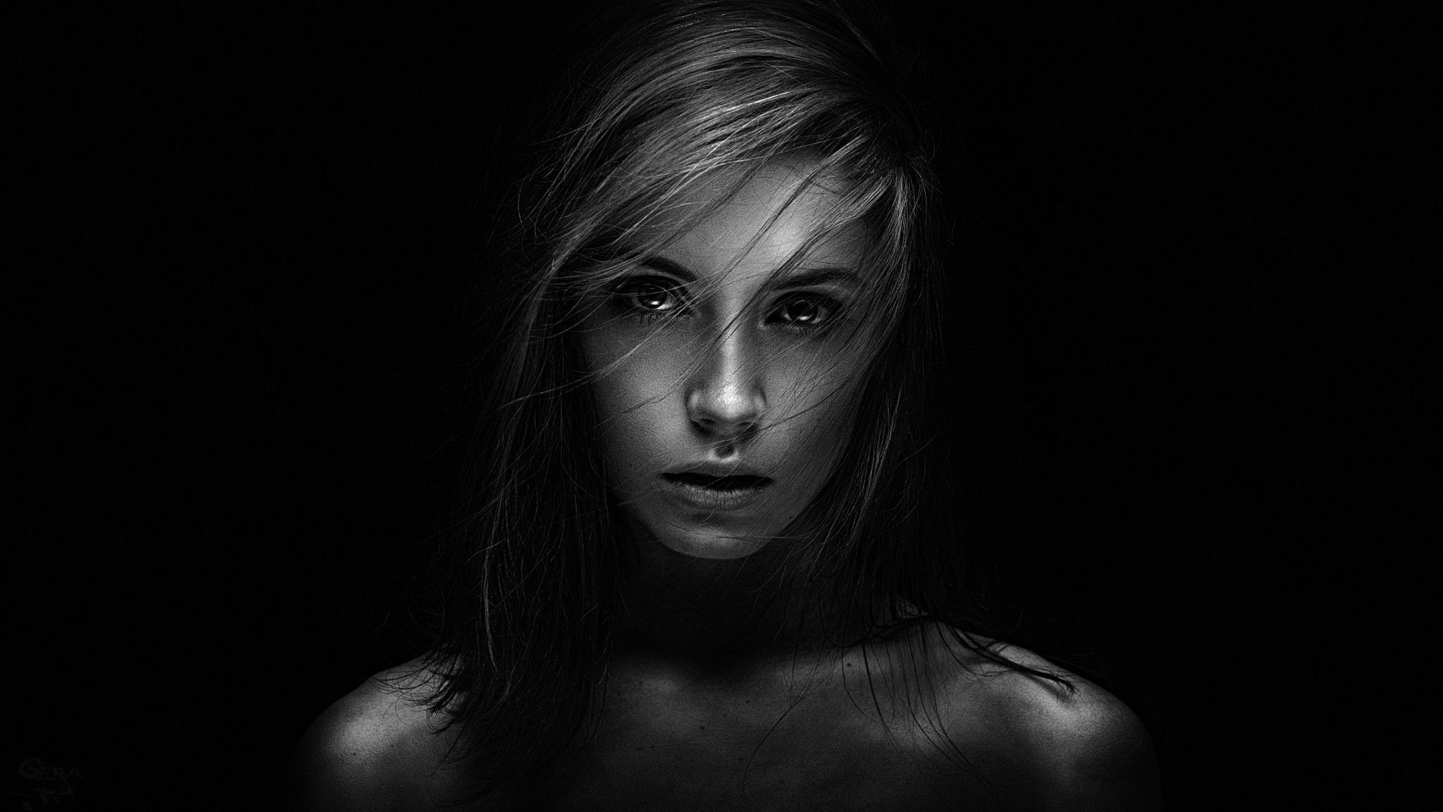 Monochrome portrait of a woman with windblown hair HD Wallpaper