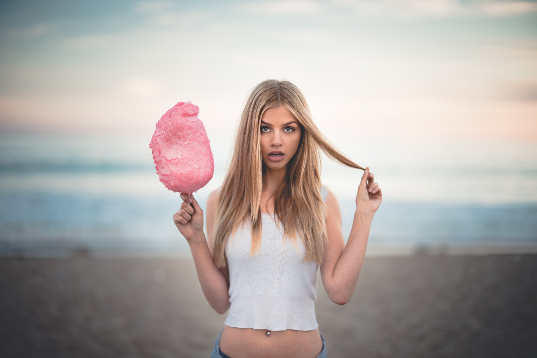 Woman with pink cotton candy on the beach HD Wallpaper