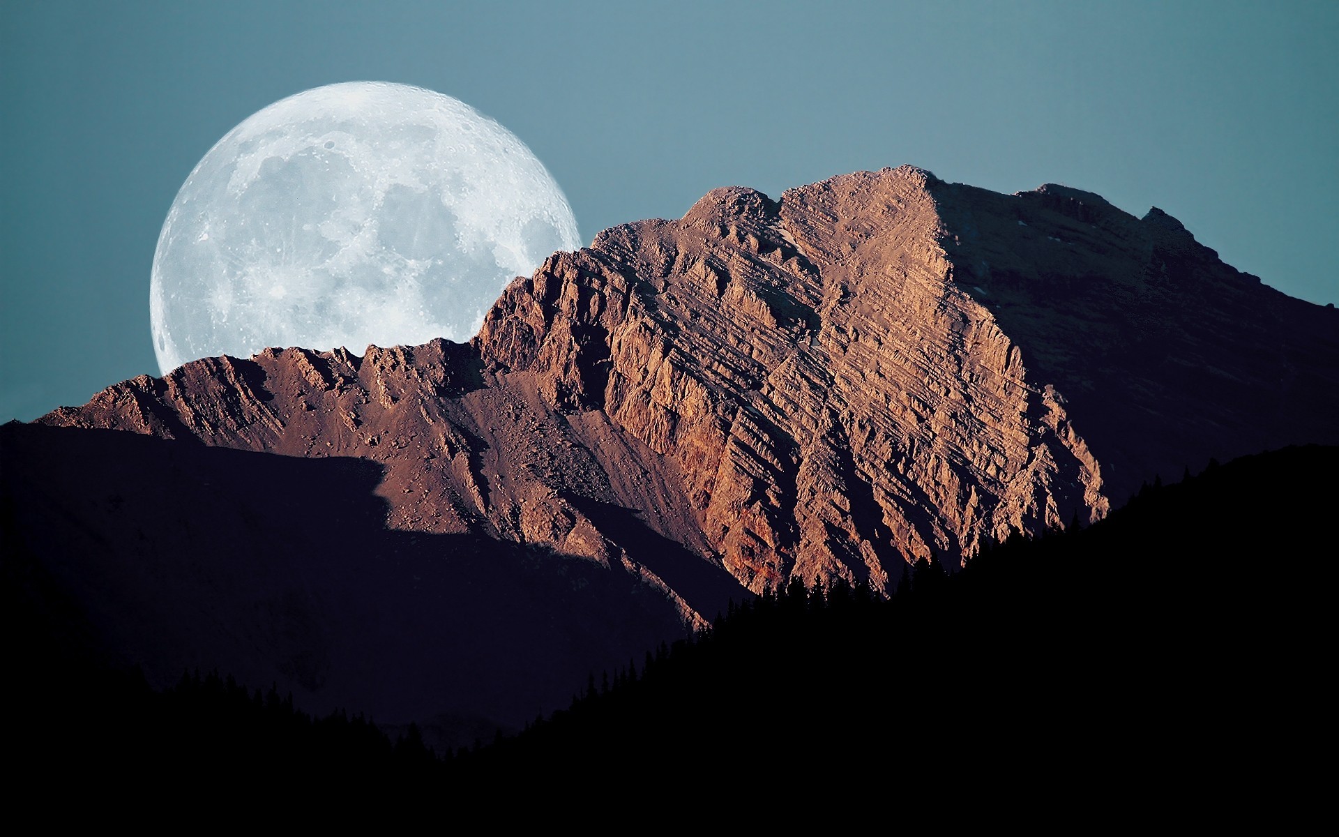 Full moon behind a rocky mountain peak HD Wallpaper