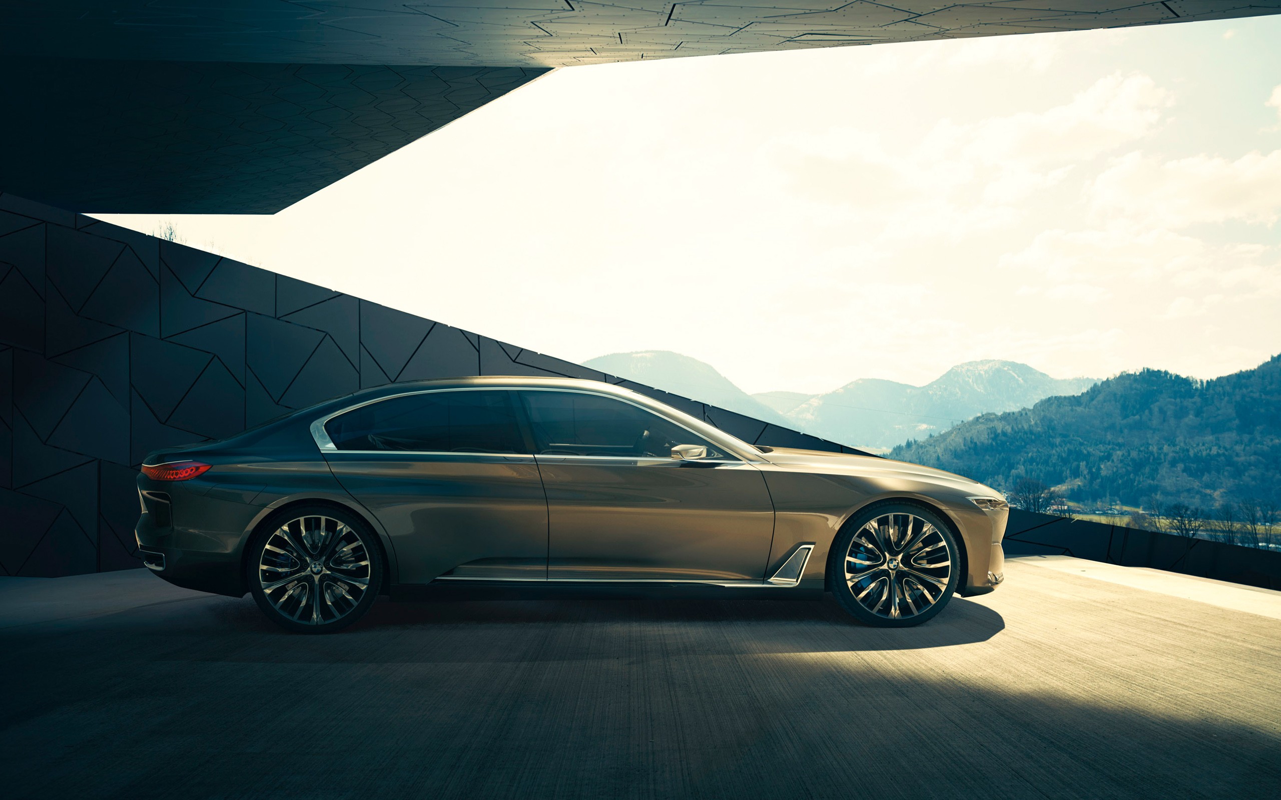 BMW luxury sedan parked near modern architecture with mountains HD Wallpaper