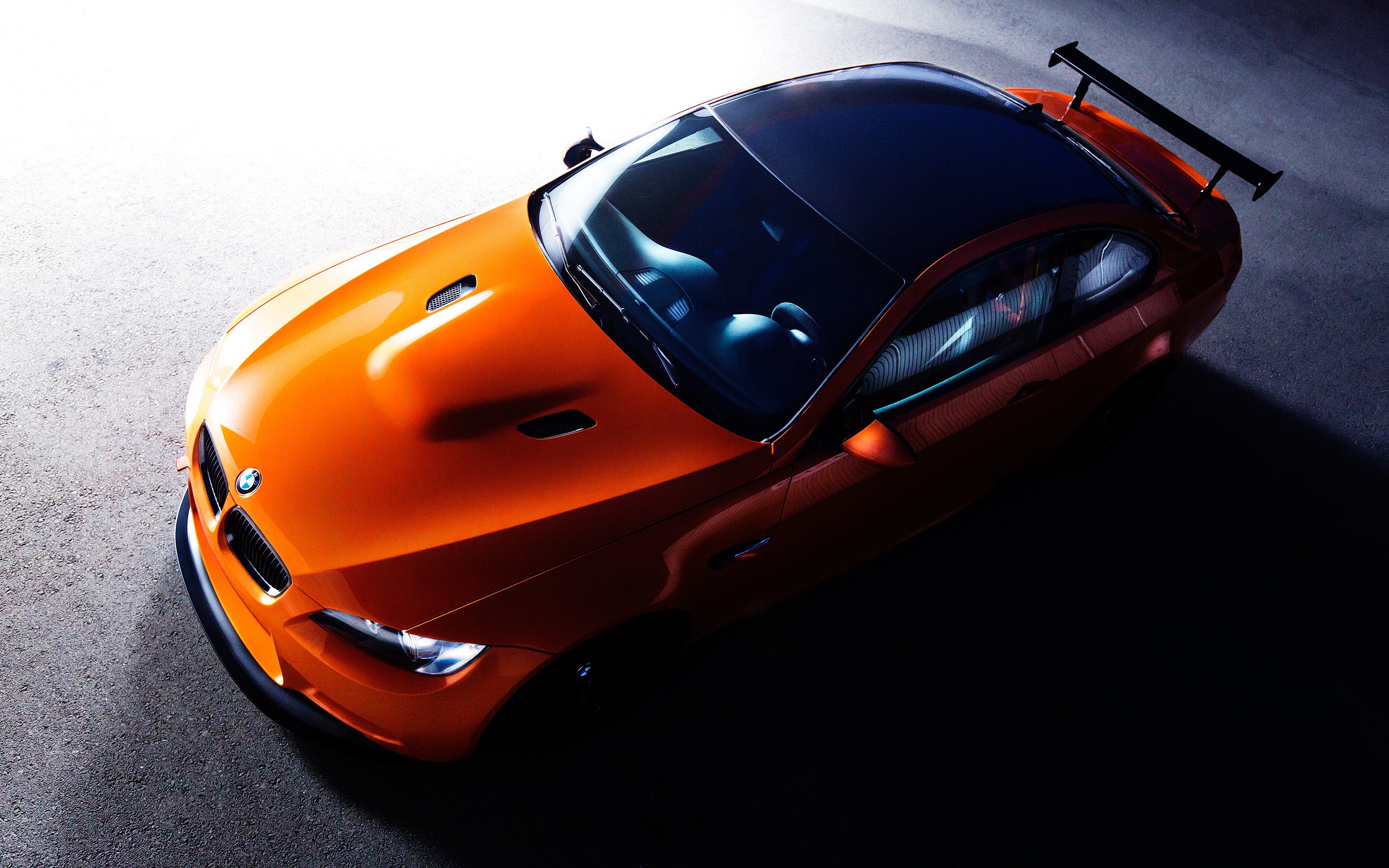 Orange BMW M3 sports car with a rear spoiler HD Wallpaper