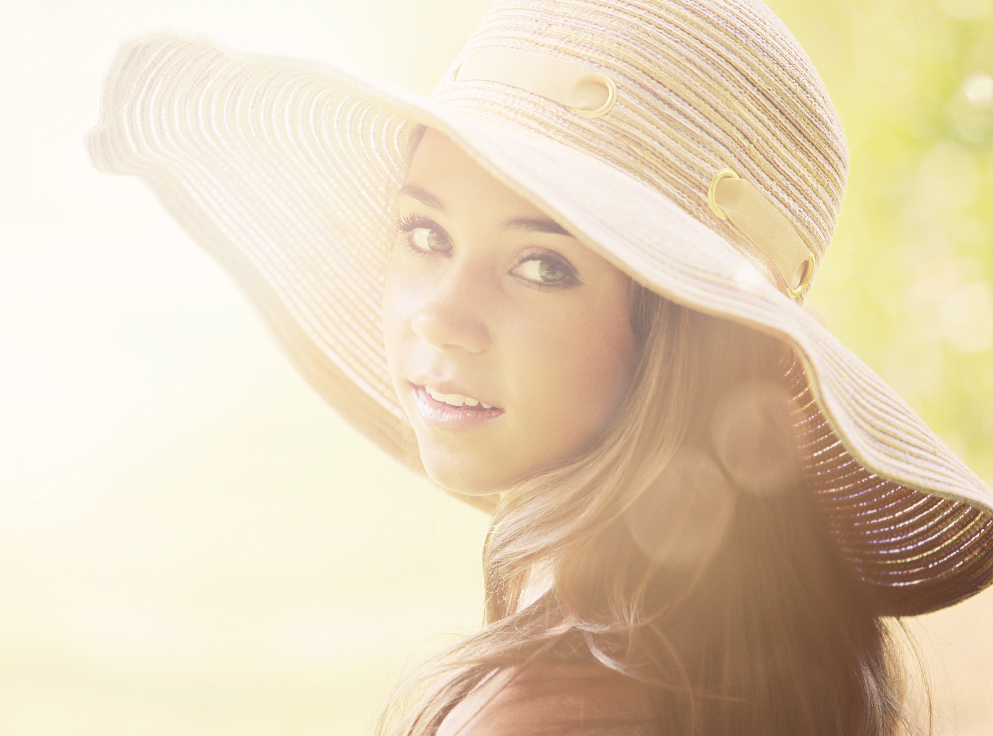 Woman wearing a wide-brimmed hat in sunlight HD Wallpaper