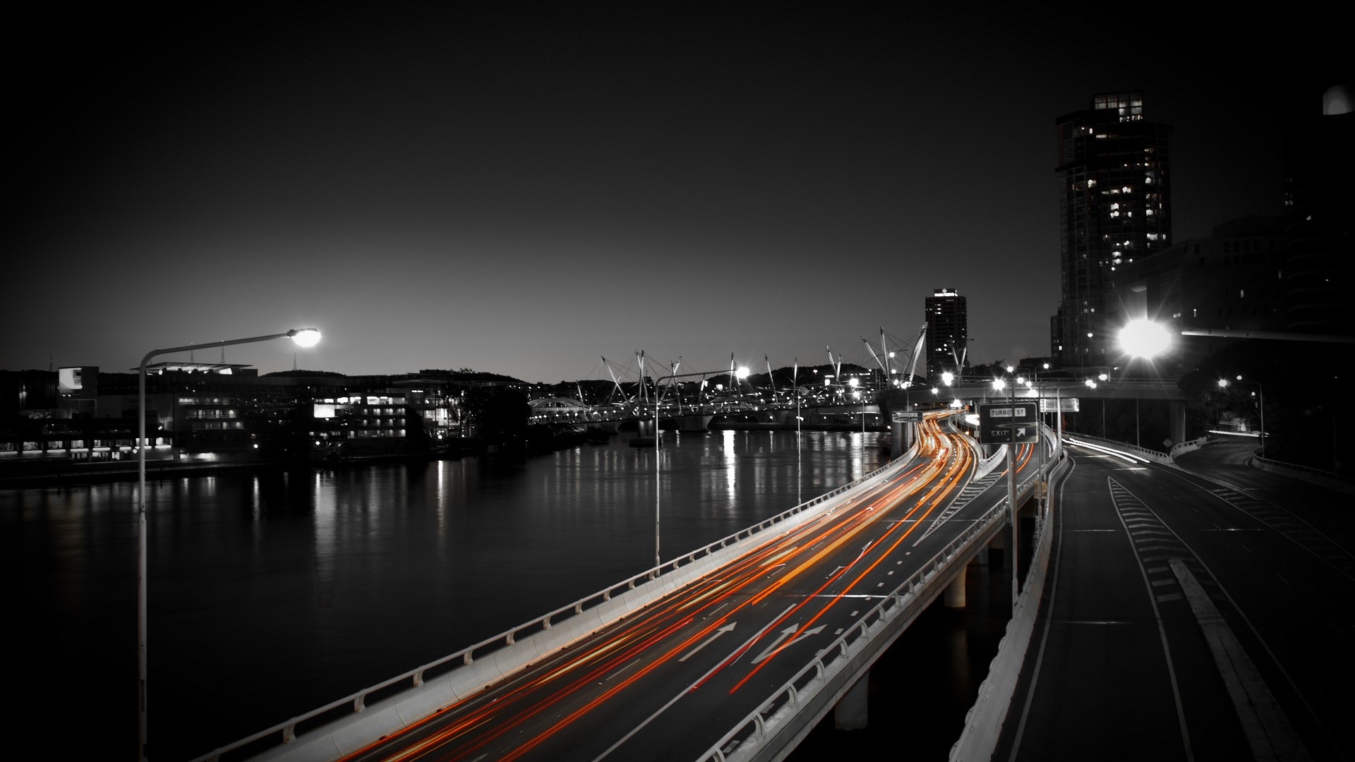 Cityscape with light trails on a bridge at night HD Wallpaper