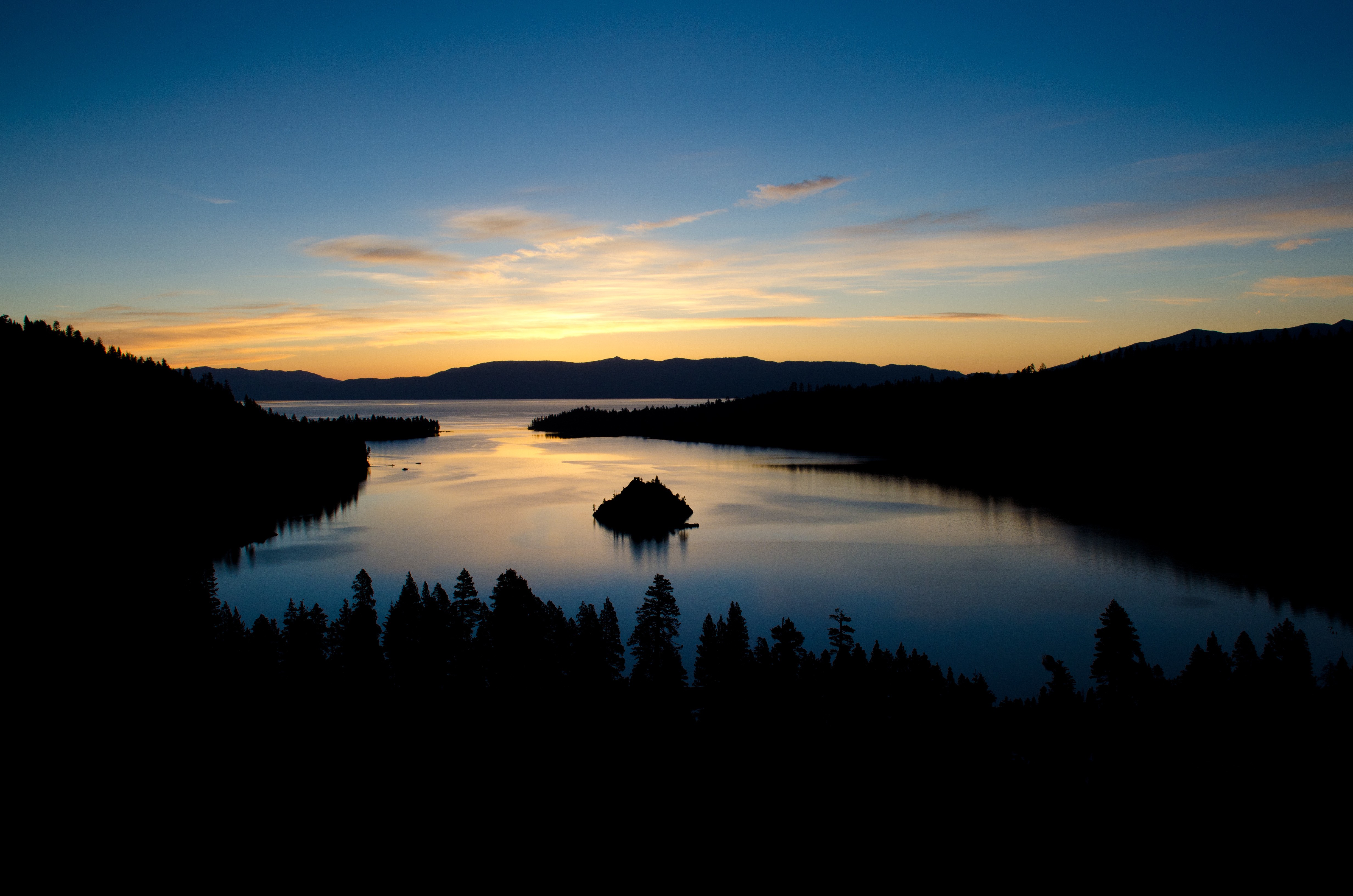 Sunset over a lake with an island and forest HD Wallpaper
