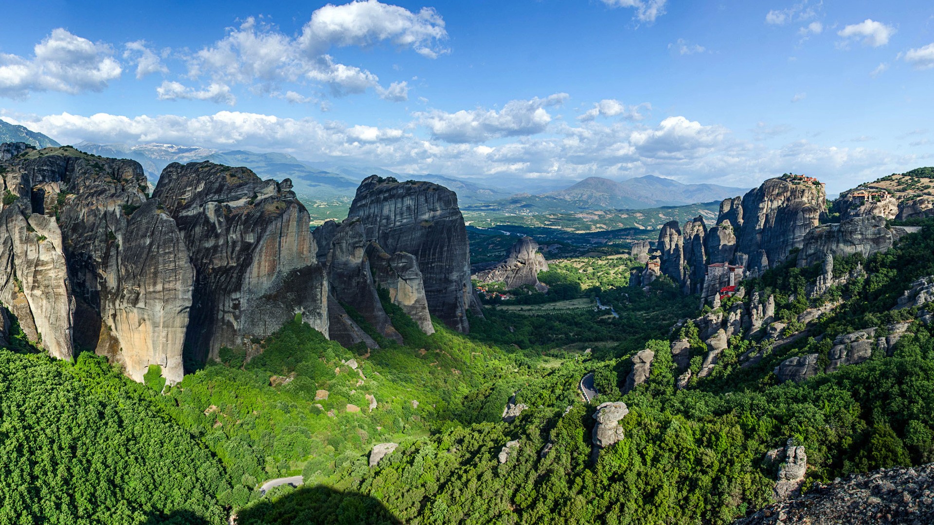 Meteora rock formations with monasteries and green forest HD Wallpaper