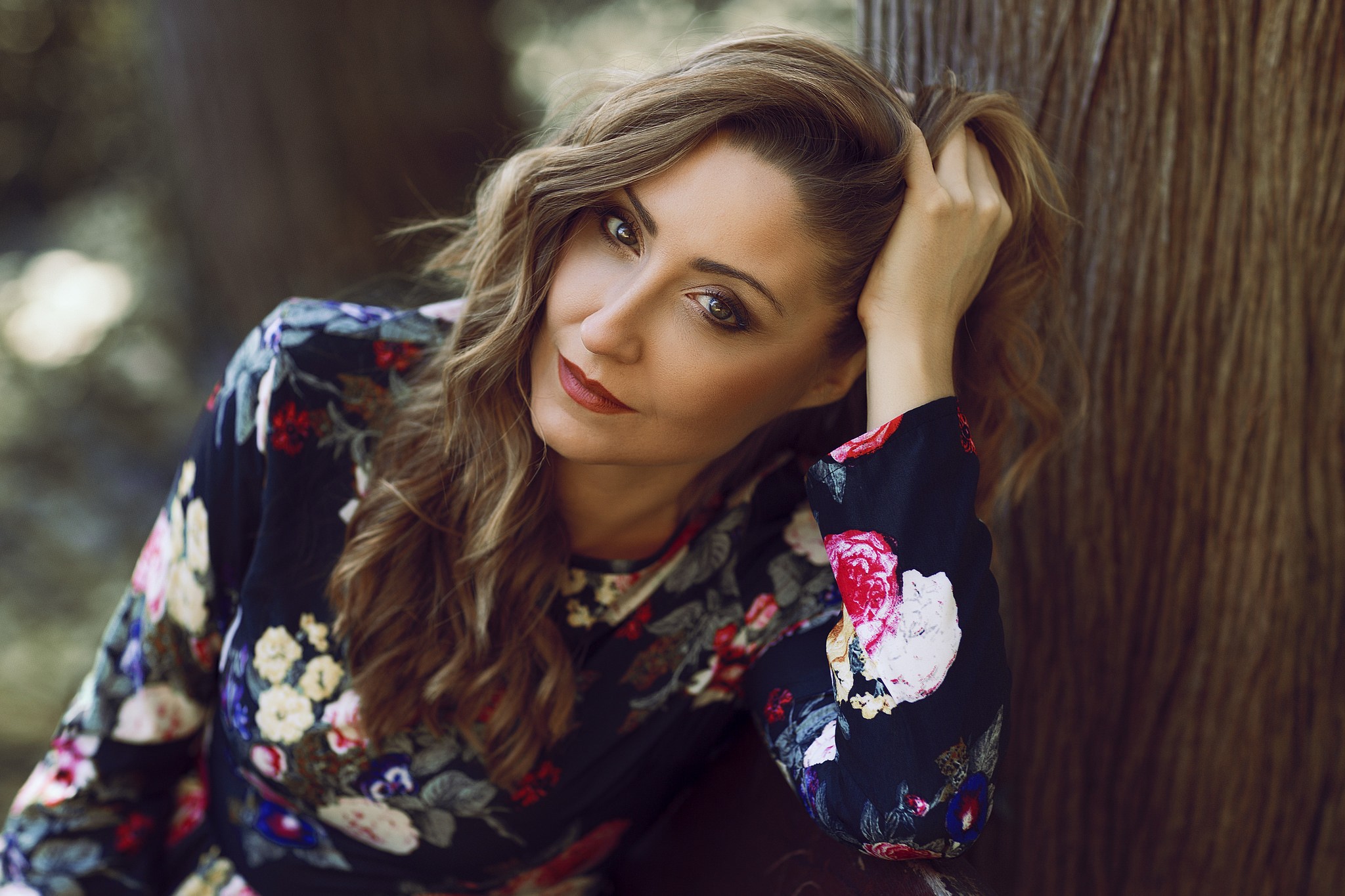 Woman with hand in hair wearing floral dress HD Wallpaper