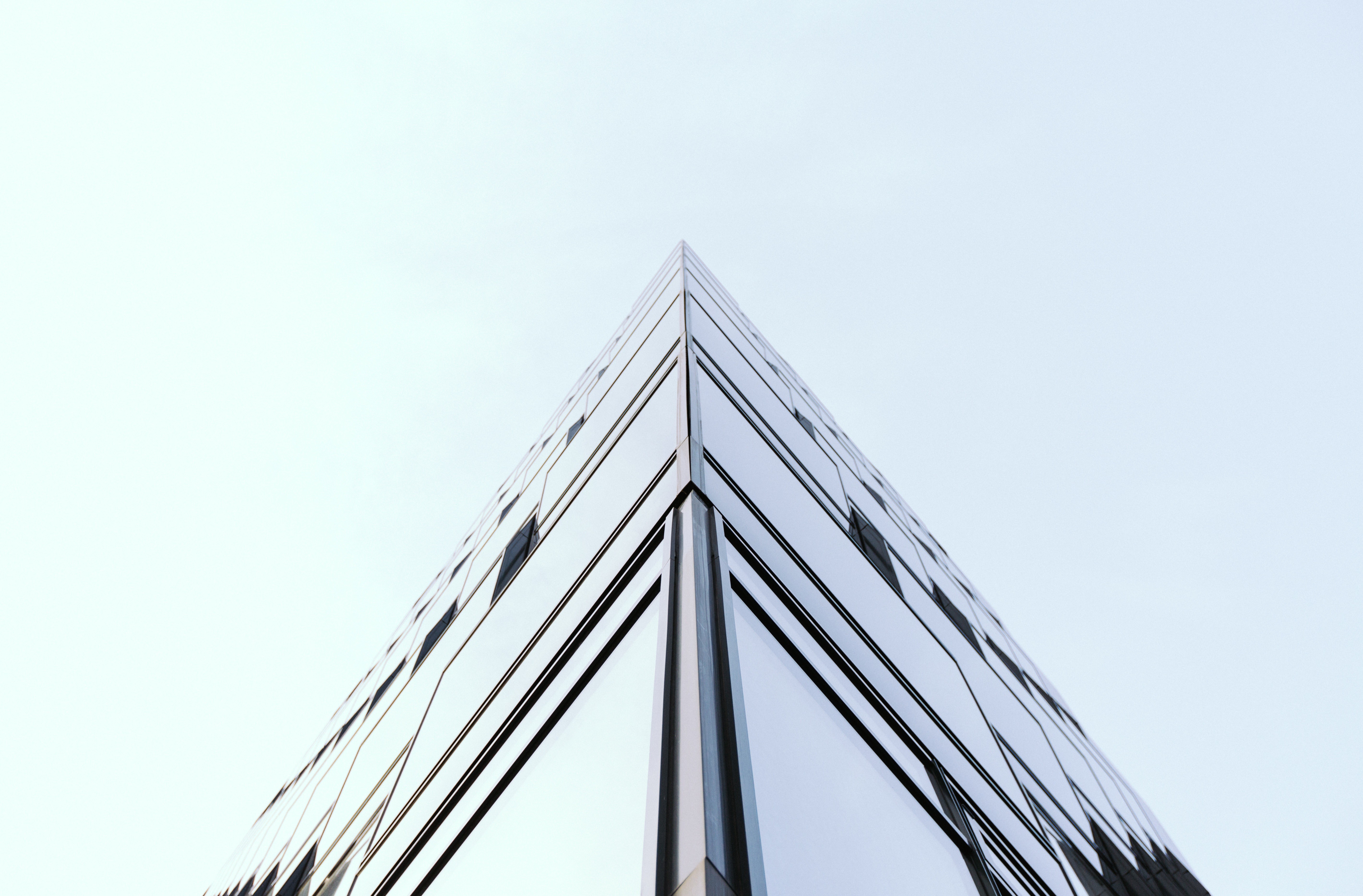 Modern glass building corner looking up at sky HD Wallpaper