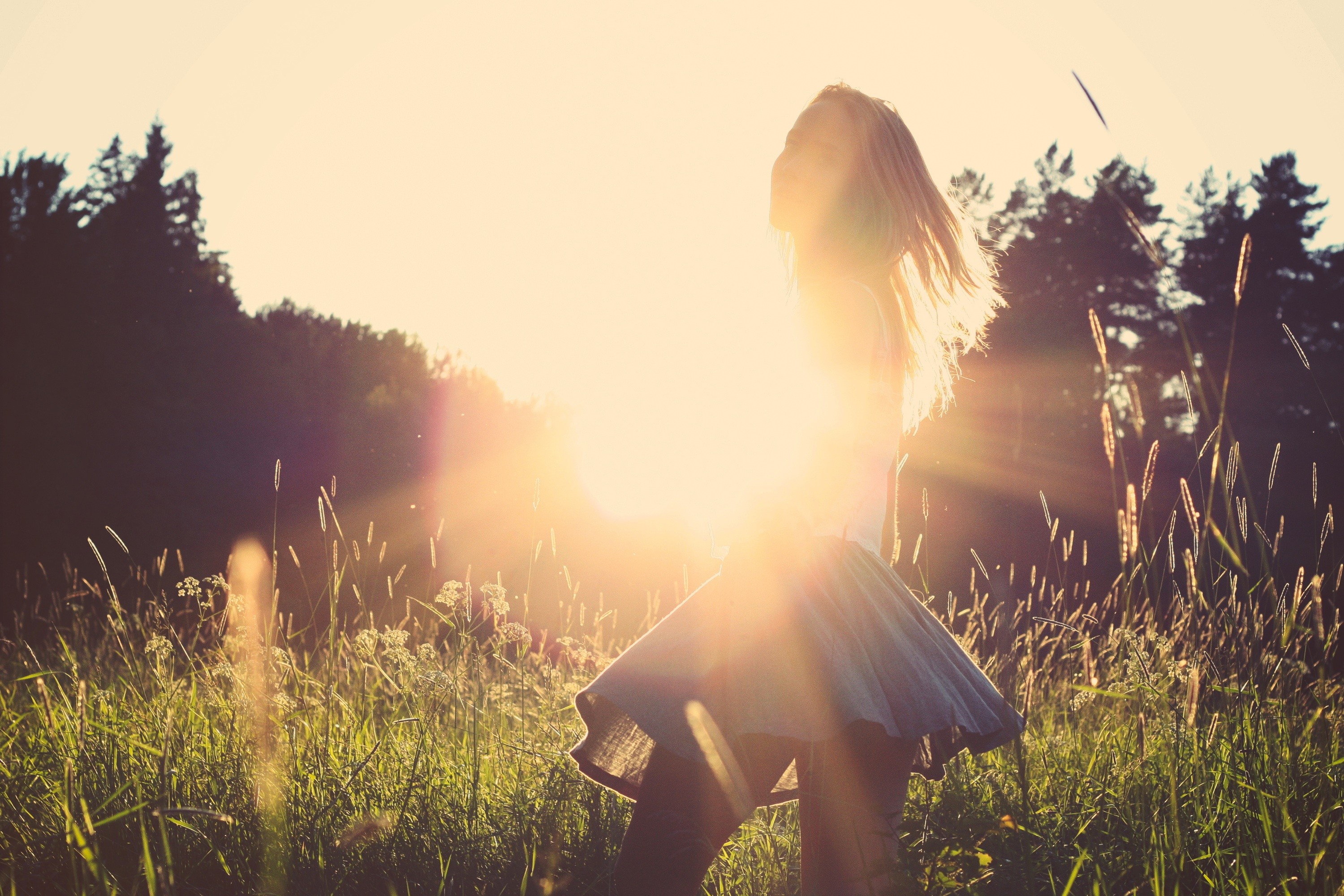 Woman with blonde hair in a field at sunset HD Wallpaper