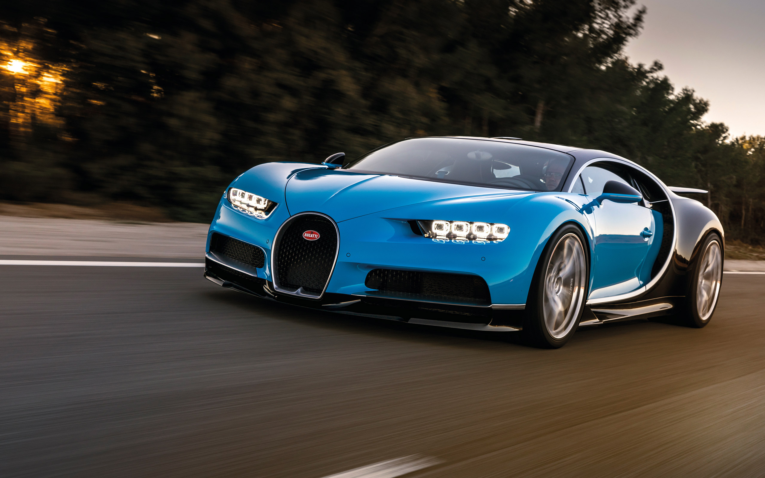 Blue Bugatti Chiron driving on a road HD Wallpaper