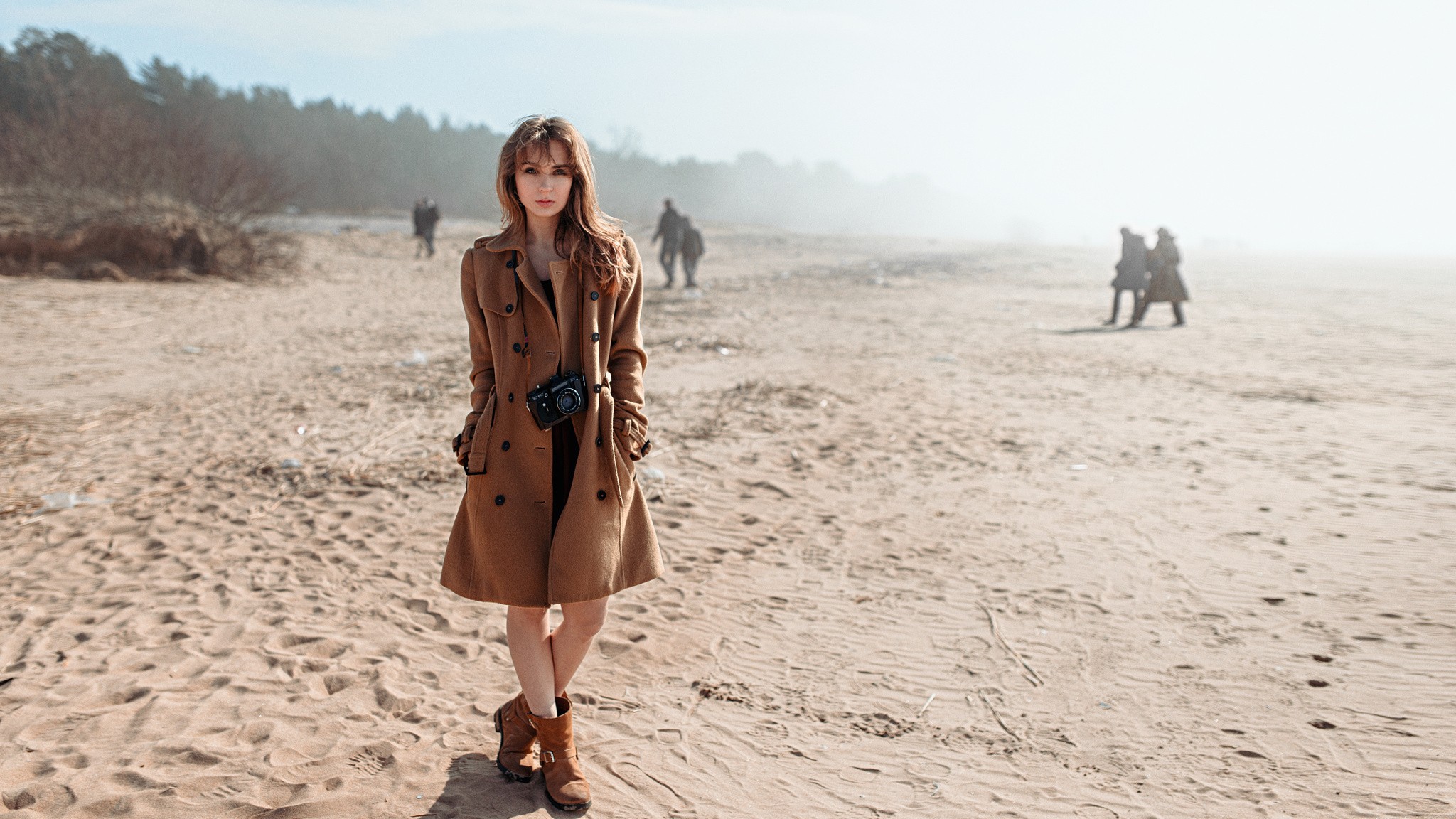 Woman with camera on a sandy beach HD Wallpaper