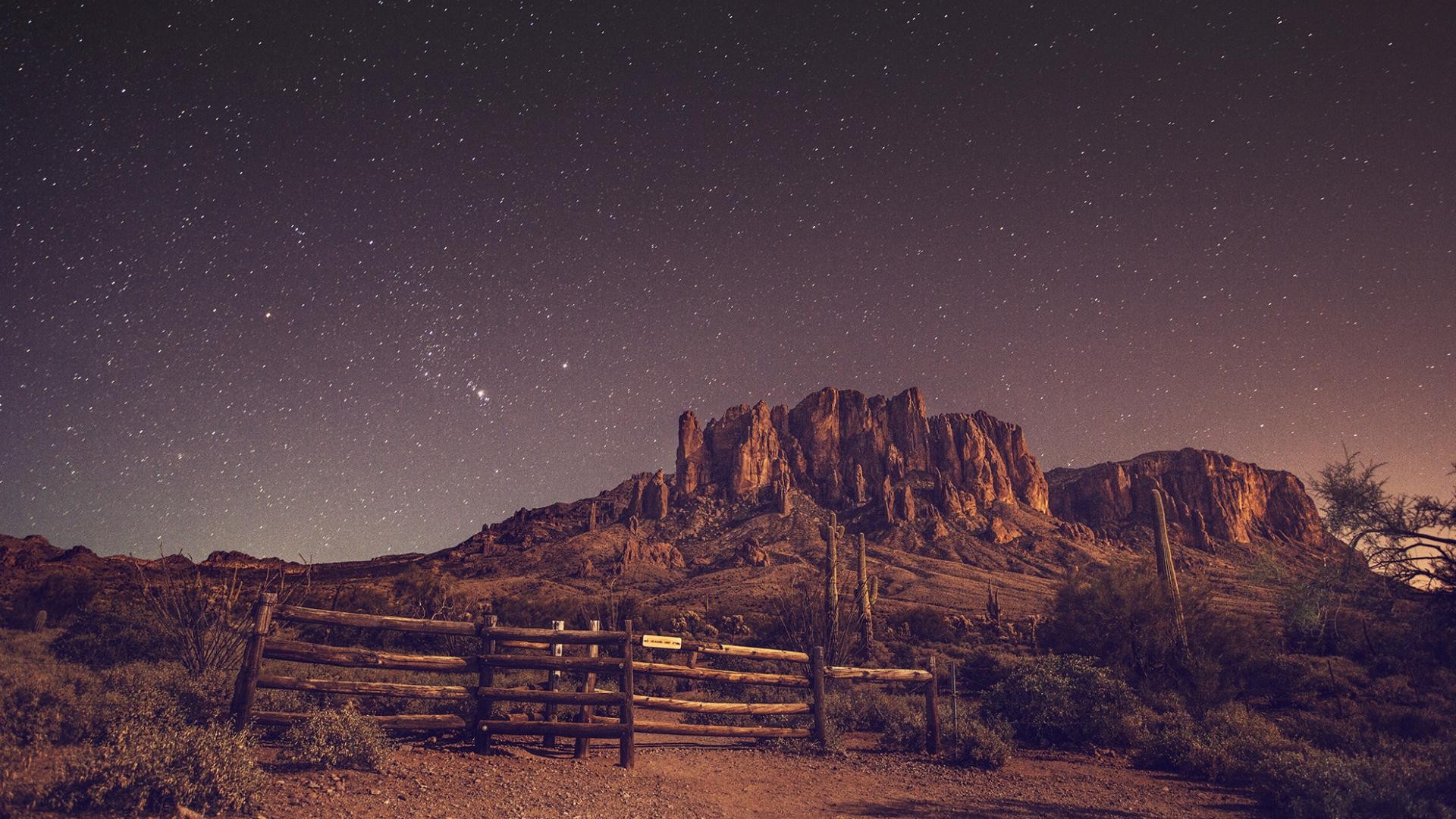 Desert landscape with mountains and stars at night HD Wallpaper